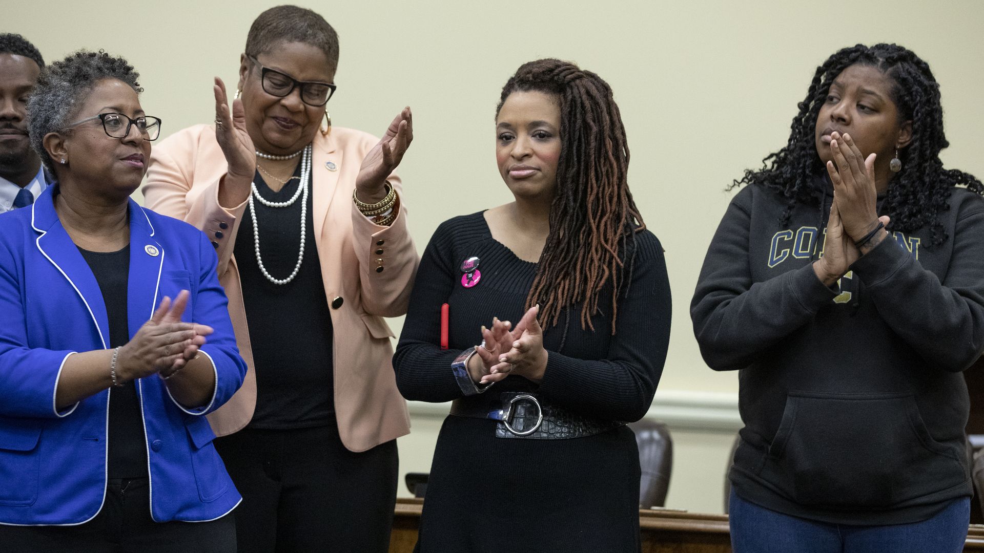 Attendees clap during a press conference at the Maryland House Office Building in Annapolis, Maryland, March 6, 2020, in advance of a bill fighting hair discrimination. 