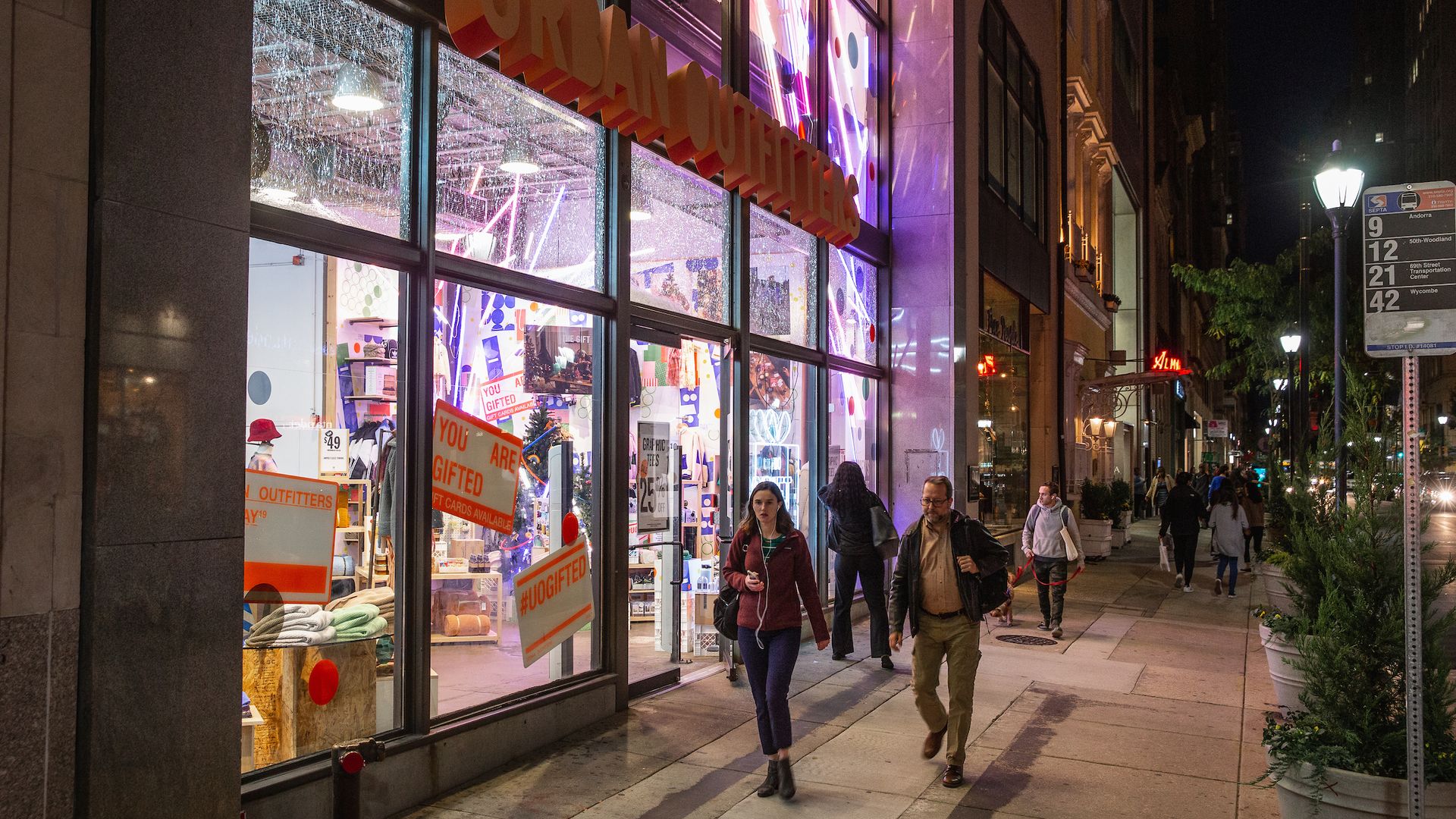 Shoppers walk past Urban Outfitters in Center City. 
