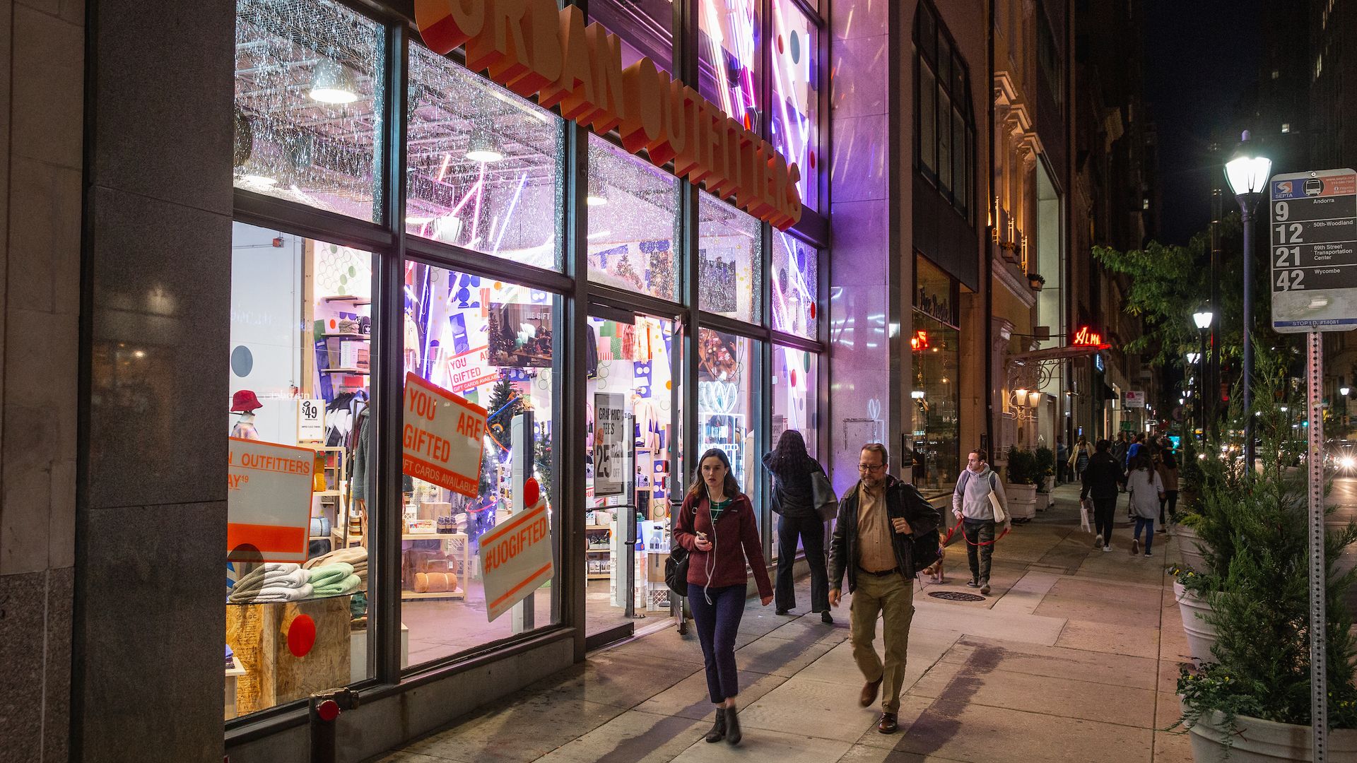 Shoppers walk past Urban Outfitters in Center City.