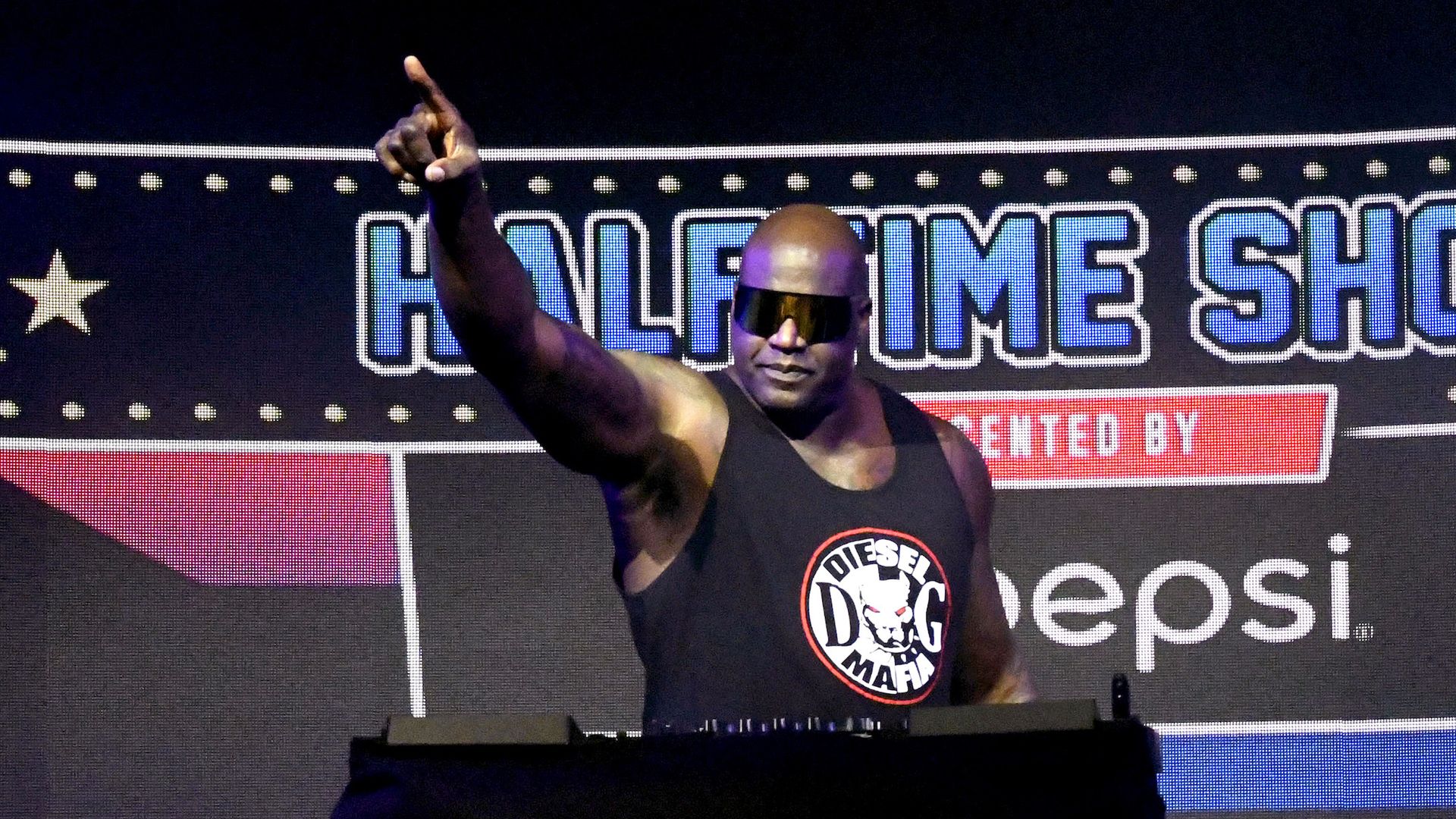 Basketball legend Shaquille O'Neal DJs at a Super Bowl event. 