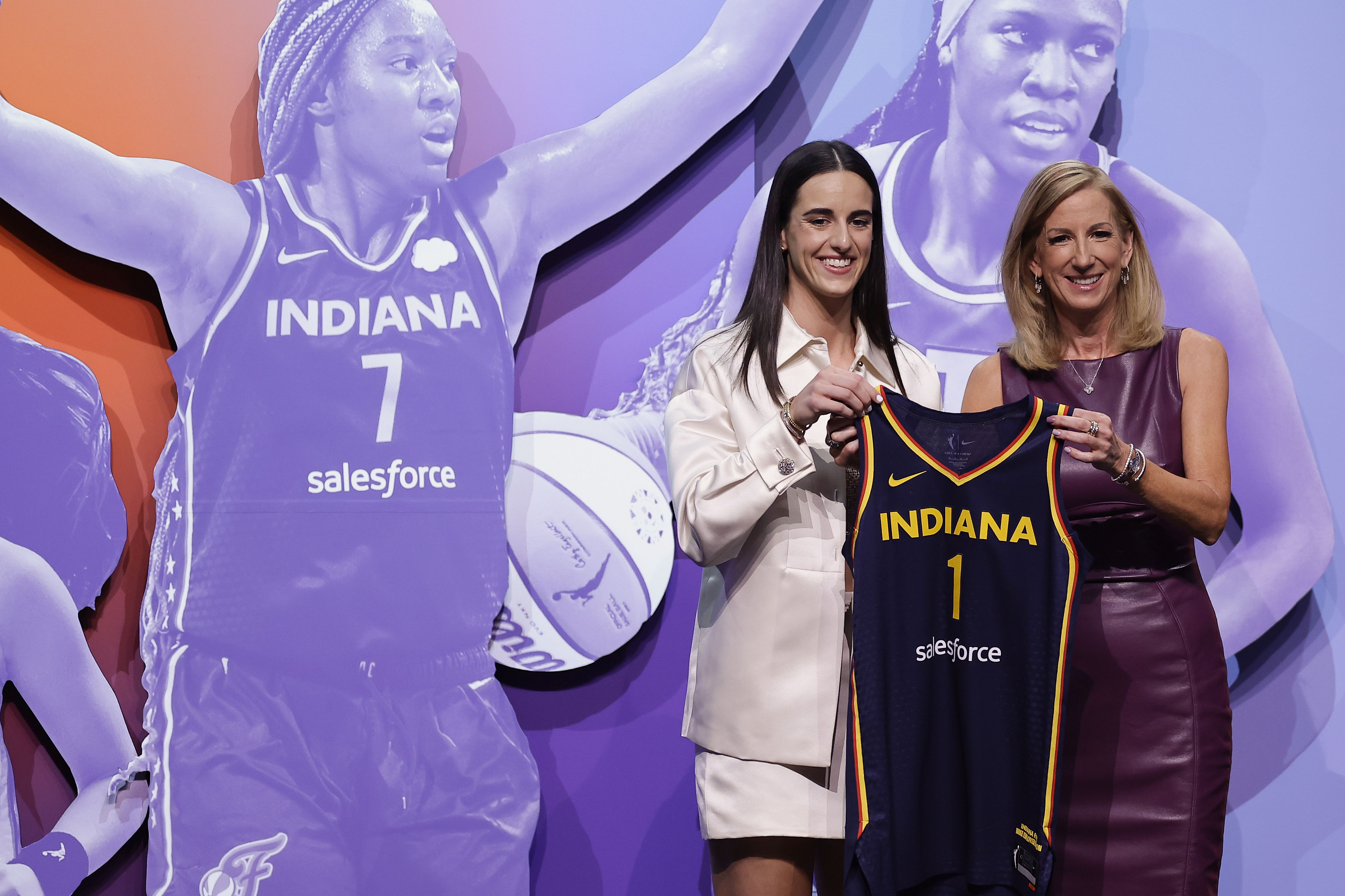  Caitlin Clark, left, poses for a photo with WNBA commissioner Cathy Engelbert, right, after being selected first overall by the Indiana Fever during the first round of the WNBA basketball draft.