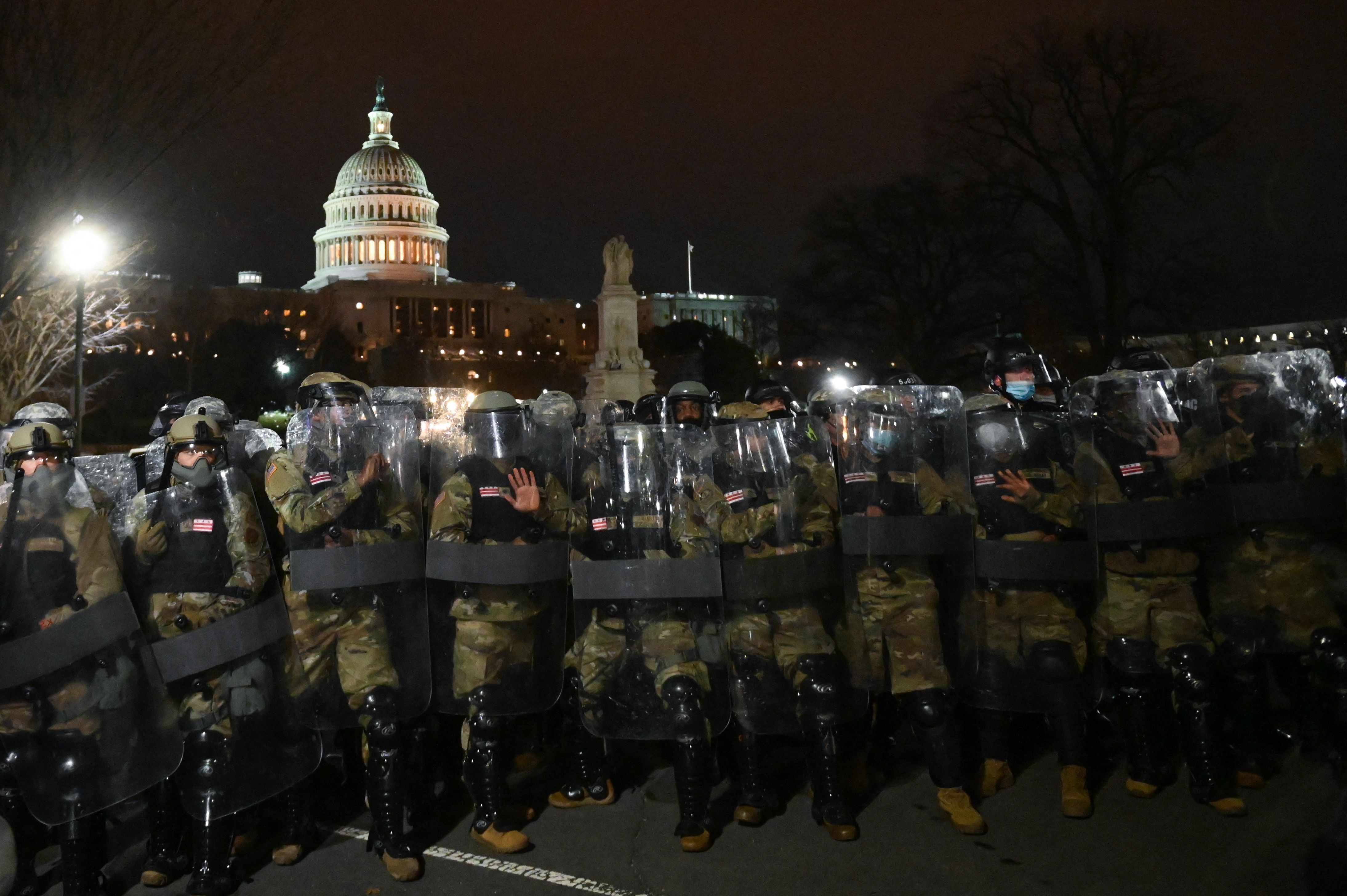 National Guard troops clear a street from protestors outside the Capitol building on January 6, 2021 in Washington, DC