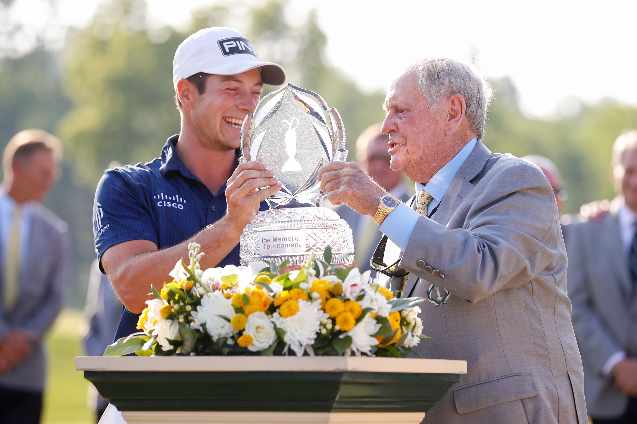Viktor Hovland and Jack Nicklaus hold a Memorial Tournament trophy. 