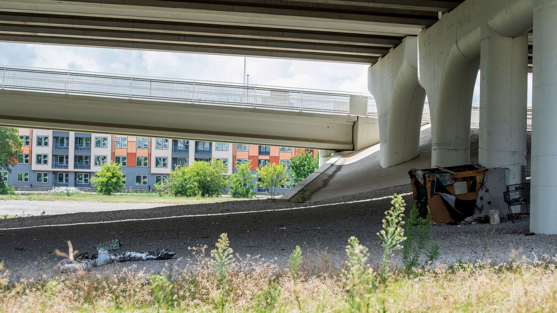 A photo of a tent under a highway