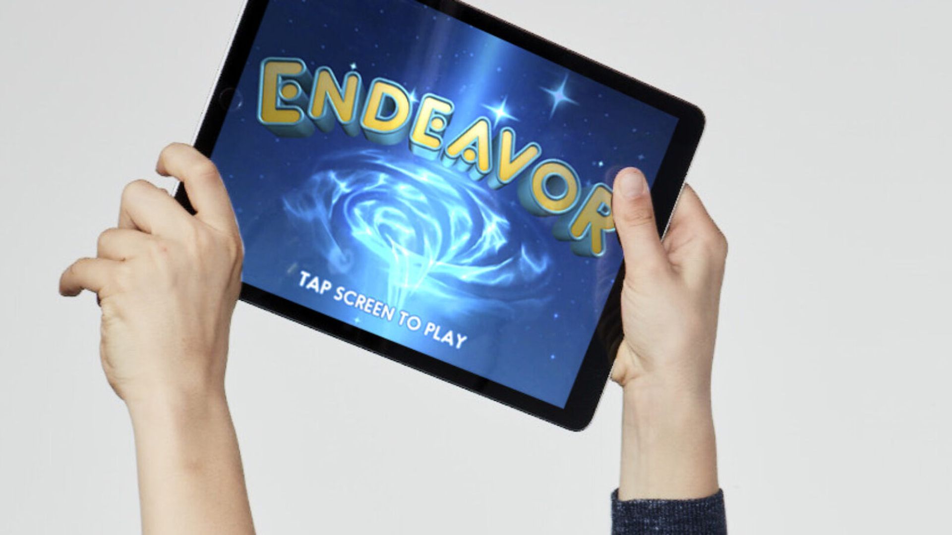 This image shows a person holding an iPad with the word "Endeavor" on it 