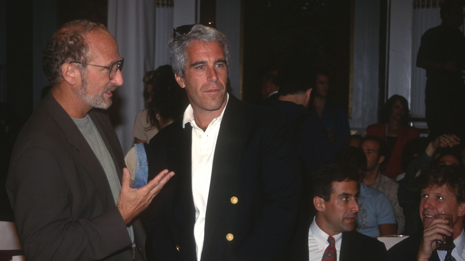 Jeffrey Epstein photographed with people surrounding him 
