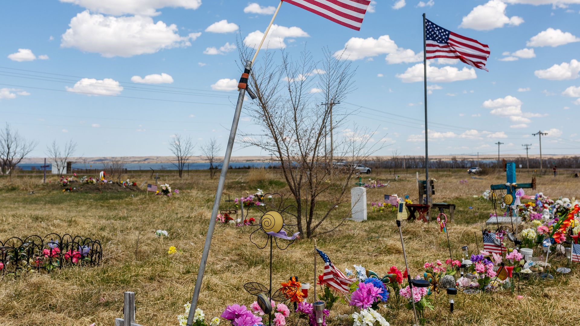 US flags fly near graves at the Lower Brule Indian Reservation