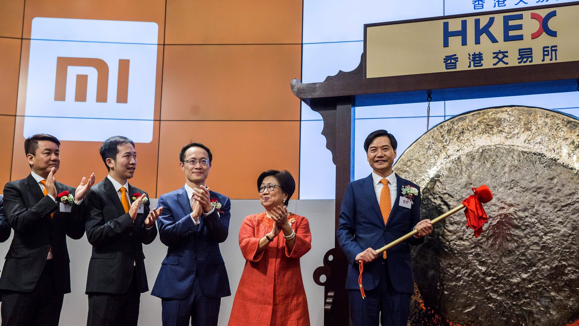 Xiaomi CEO Lei Jun hits a gong at the Hong Kong Stock Exchange on July 9, 2018.