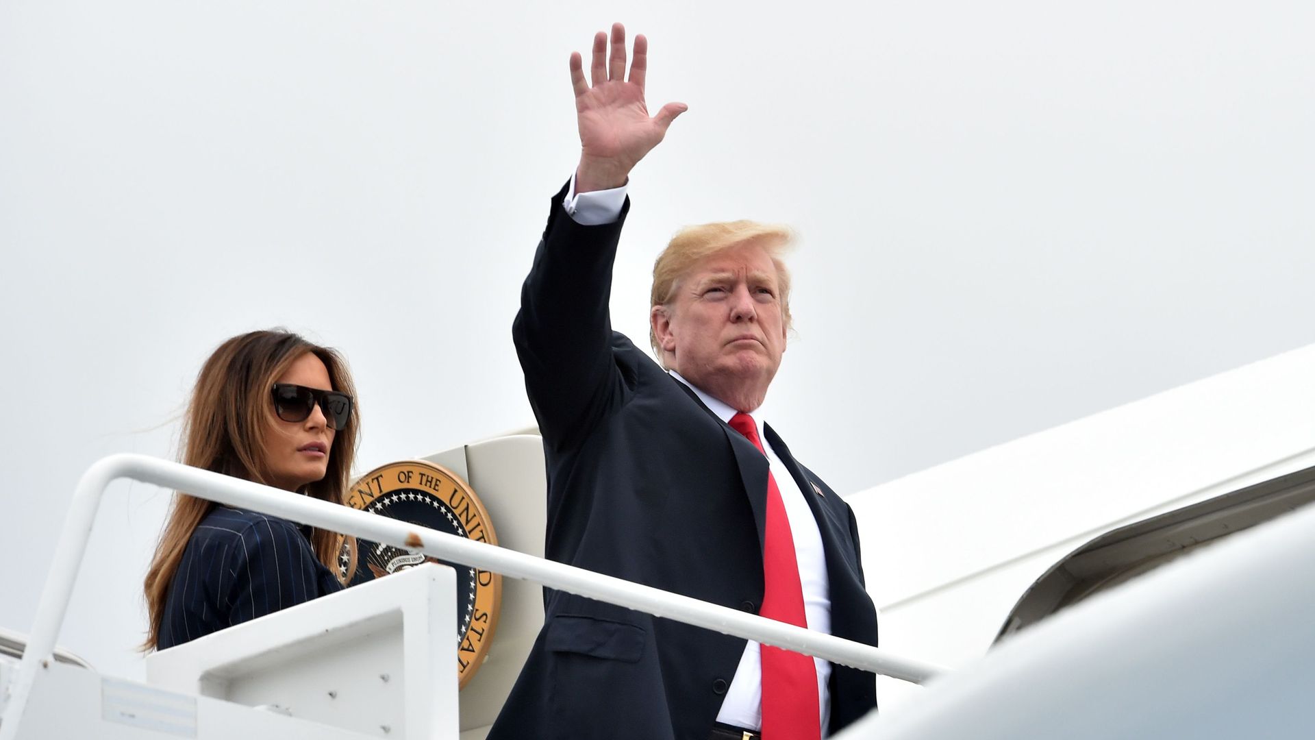 President Trump waves from Air Force One as he boards with Melania. 