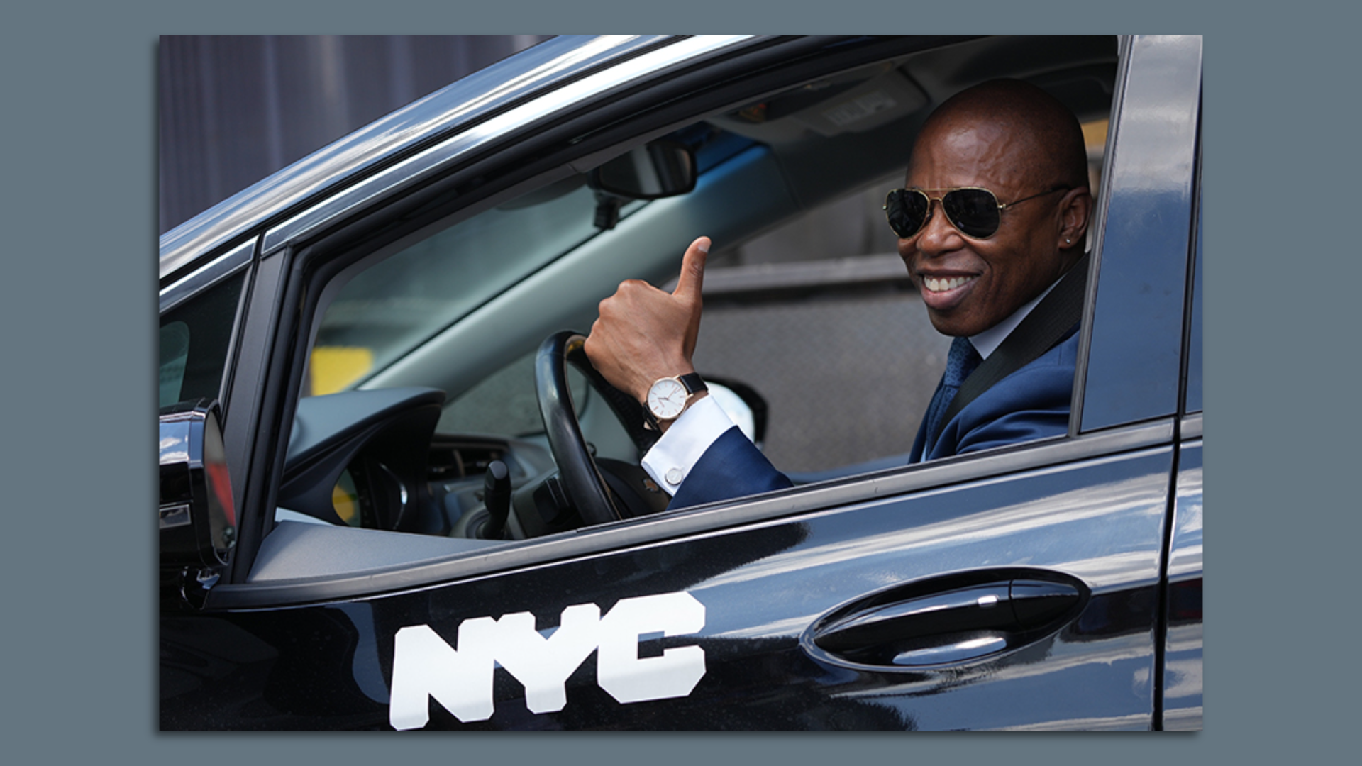 New York Mayor Eric Adams poses in a car equipped with speed-limiting technology.