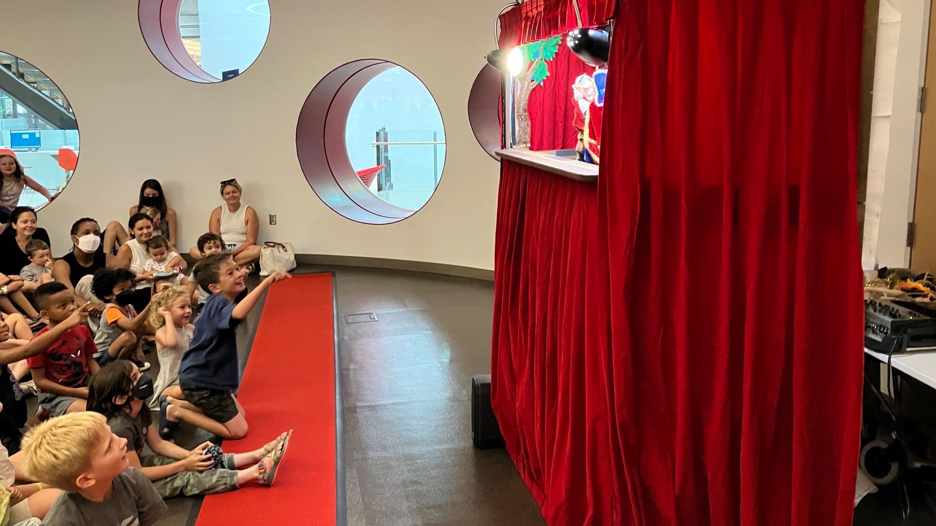 Kids enjoying a puppet show at Austin Public Library.