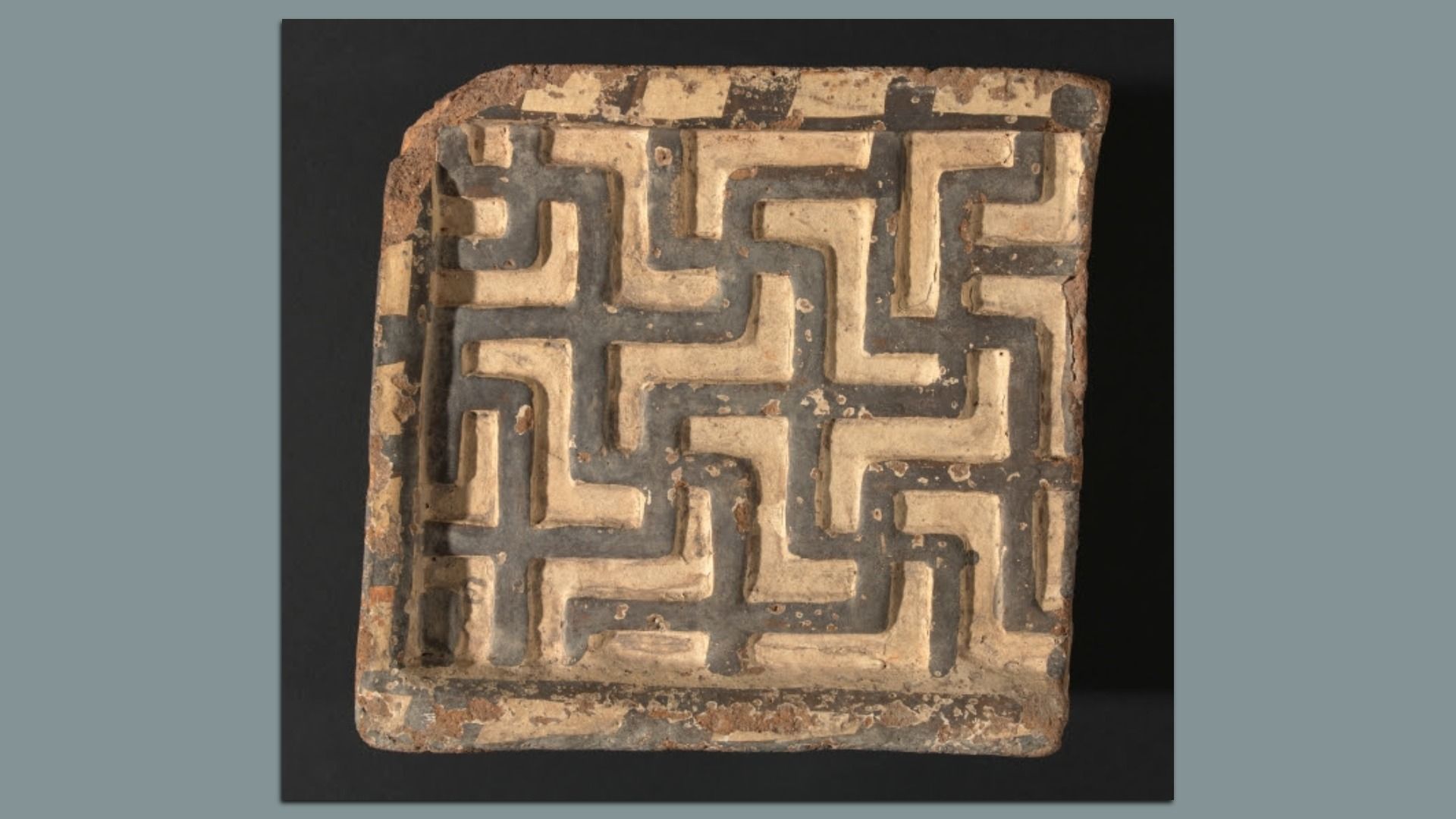 ancient polychrome terracotta tile (looks like a marble game)