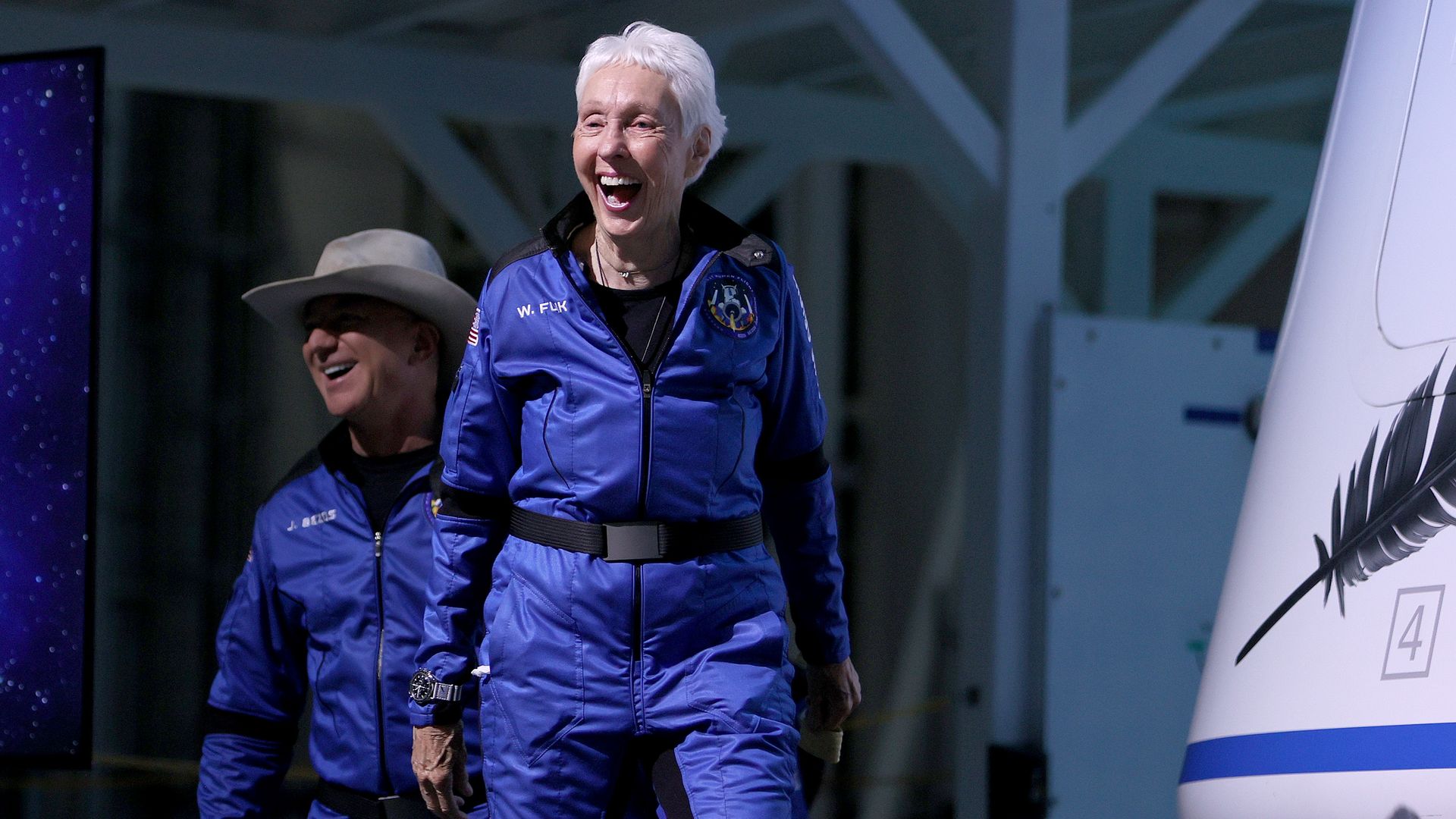 Jeff Bezos and Wally Funk arrive for a press conference after flying into space in the Blue Origin New Shepard rocket on July 20, 2021 in Van Horn, Texas.