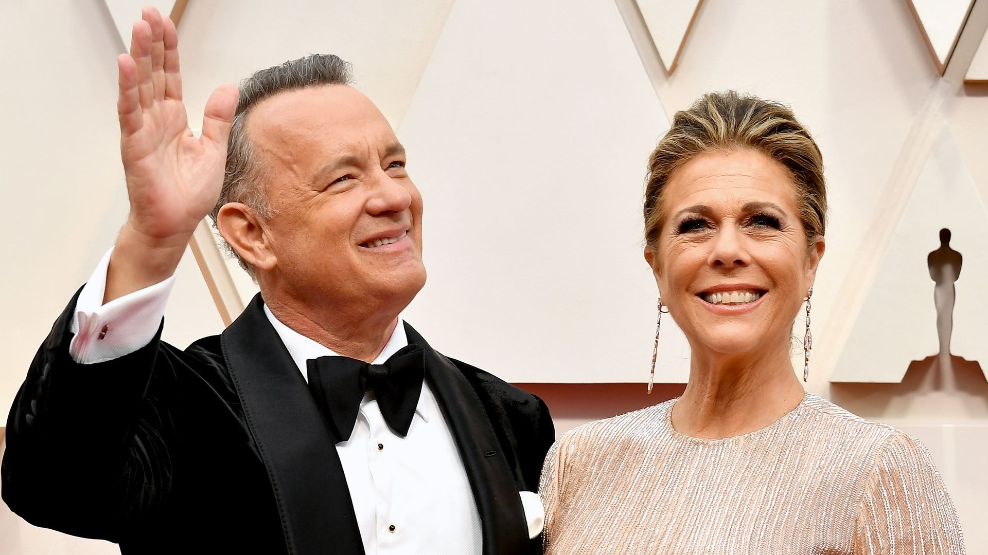 In this image, Tom Hanks and Rita wave