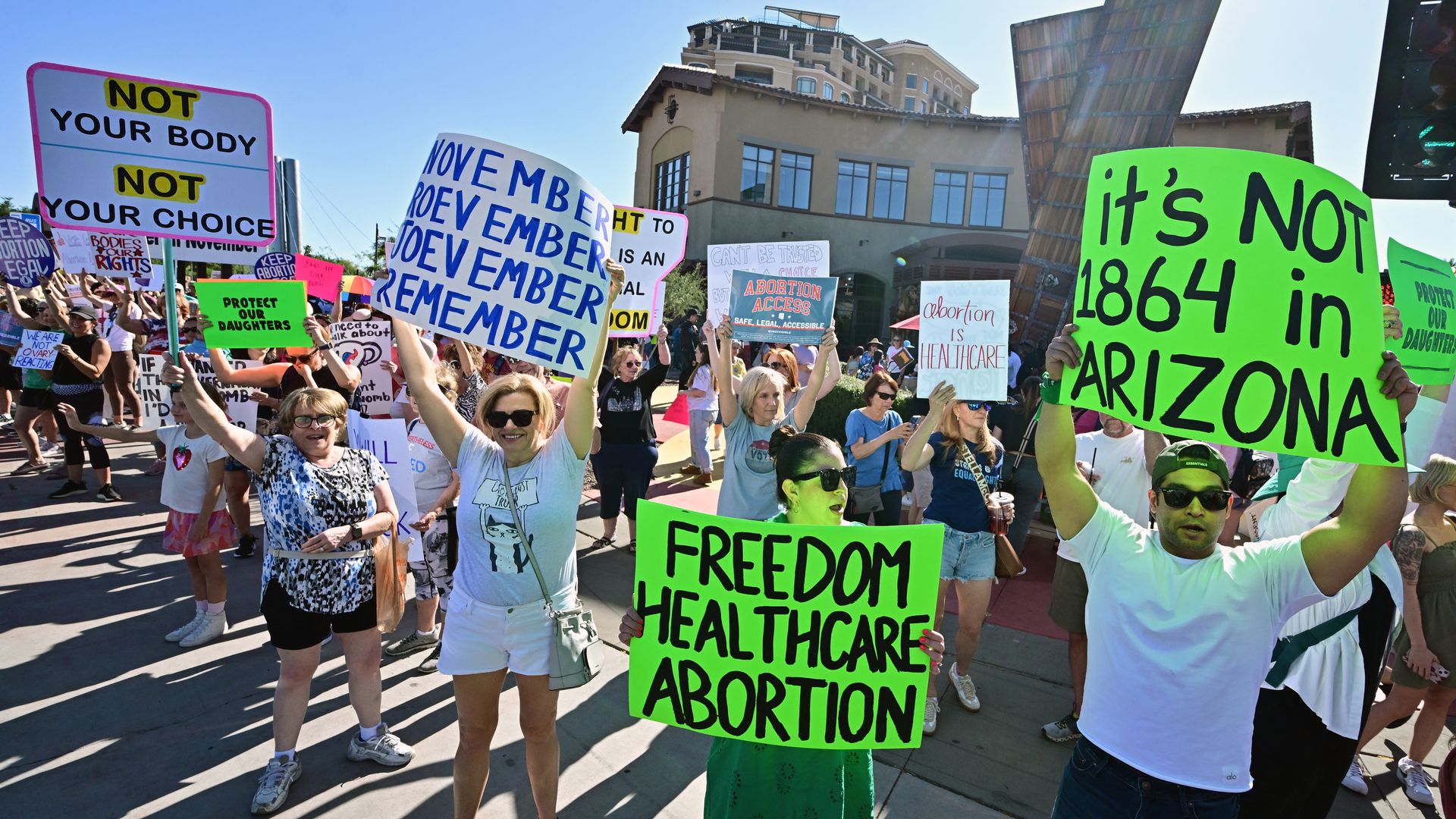 A group of protesters hold signs with pro abortion rights messages. 