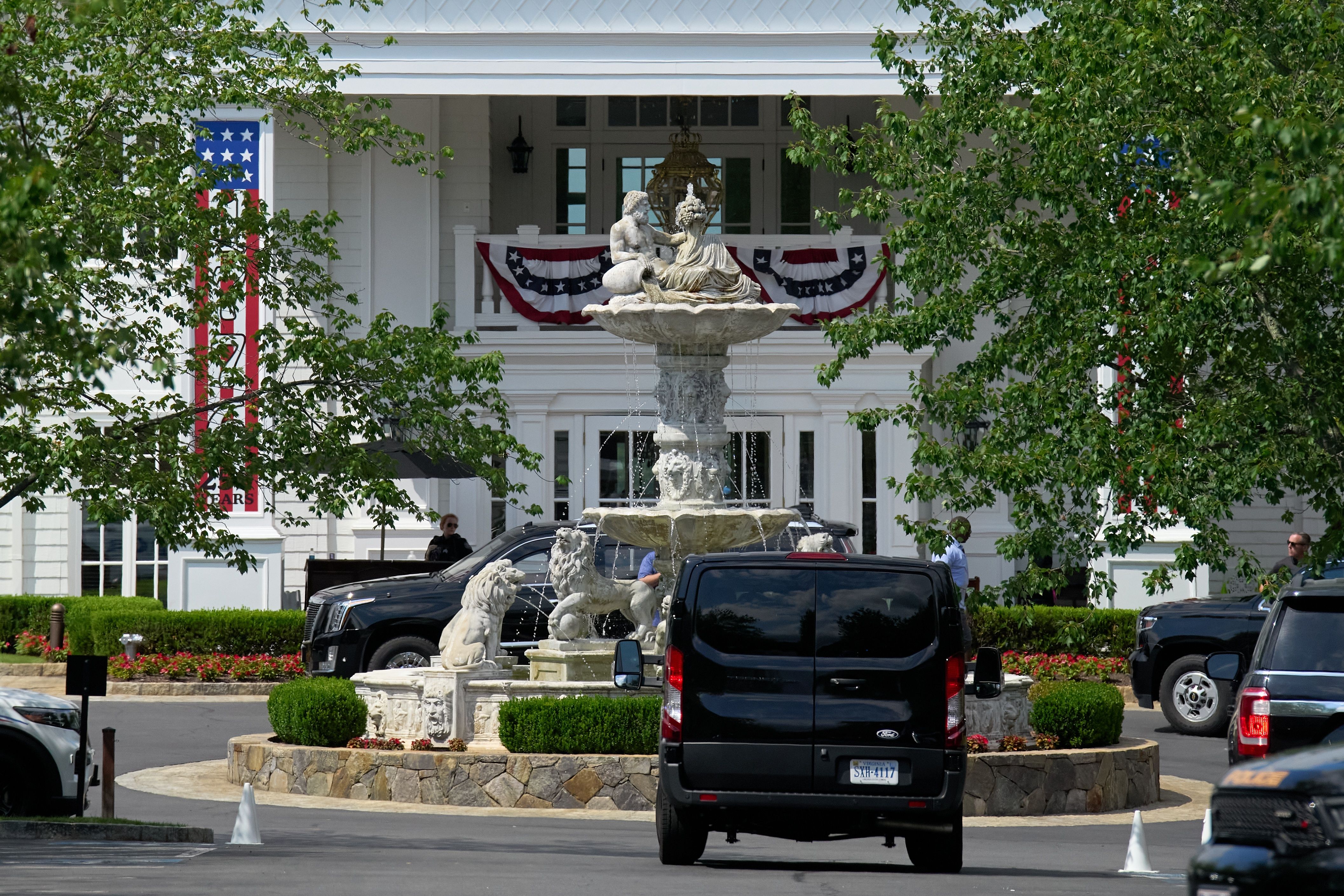 Patriotic bunting in honor of America 250 is seen by President Donald Trump's motorcade at Trump National Golf Club, in Sterling, Va., Saturday, July 25, 2026. (AP Photo/Jacquelyn Martin)