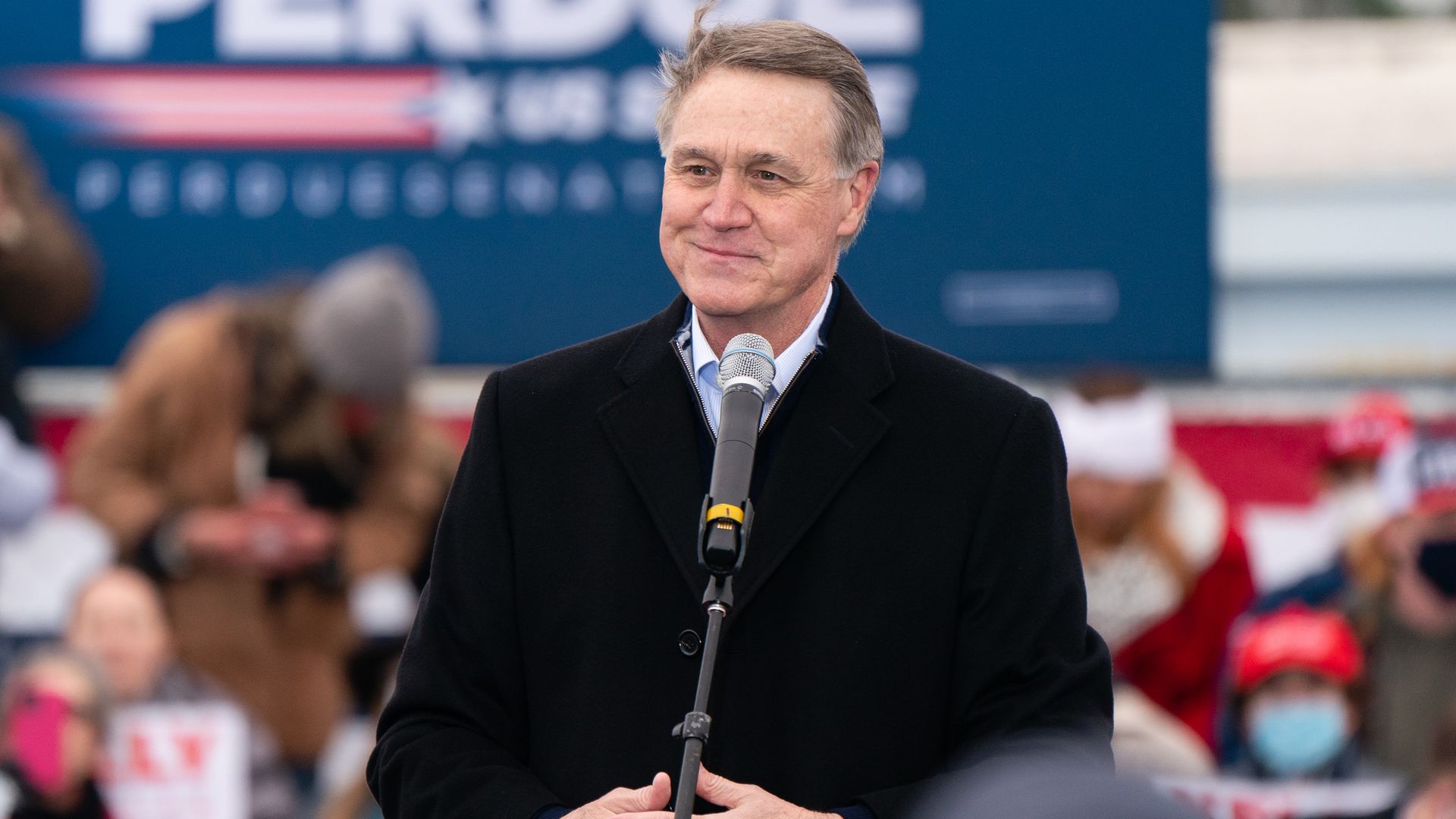 David Perdue at a microphone