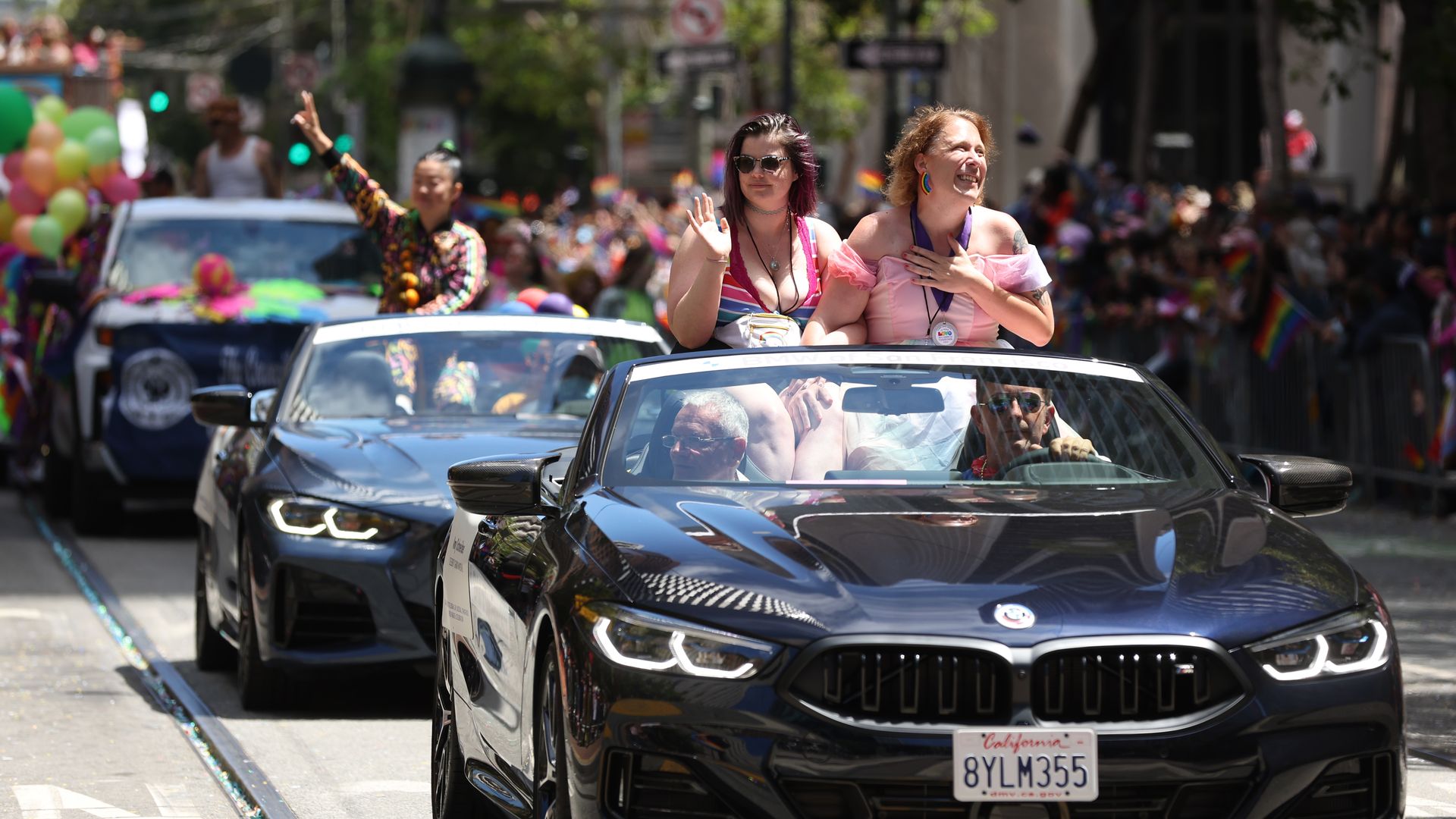 Amy Schneider sits in a convertible during the SF Pride parade.
