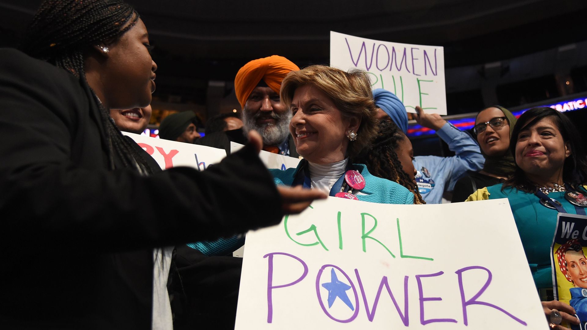 Women holding signs at the Democratic National Convention