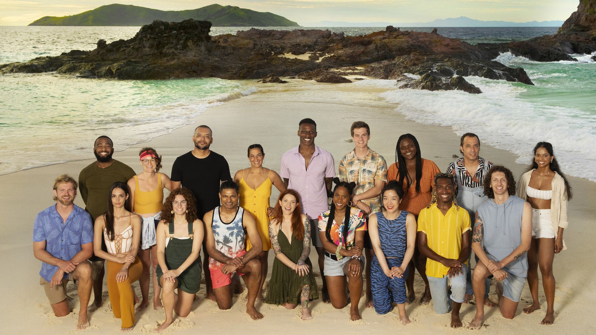 Contestants on Survivor post for a group photo on the beach.