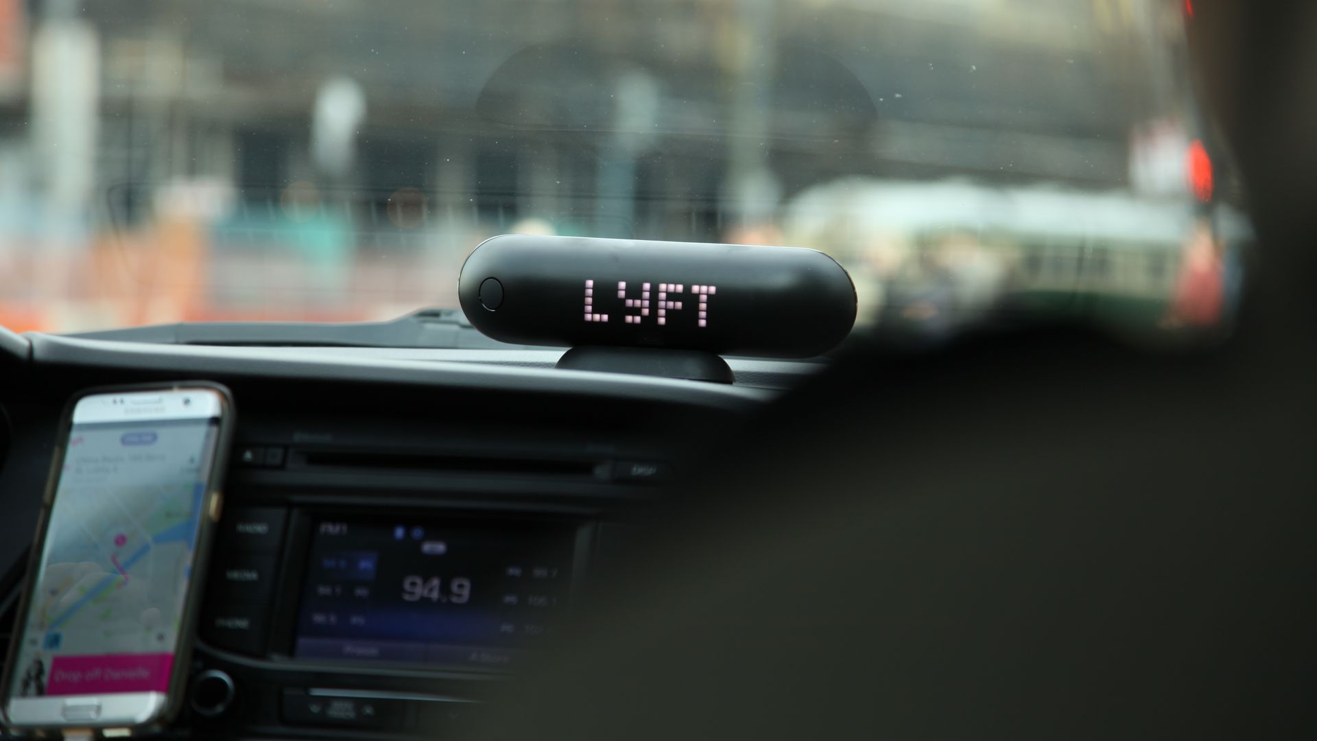 Car dashboard with lyft sign on it