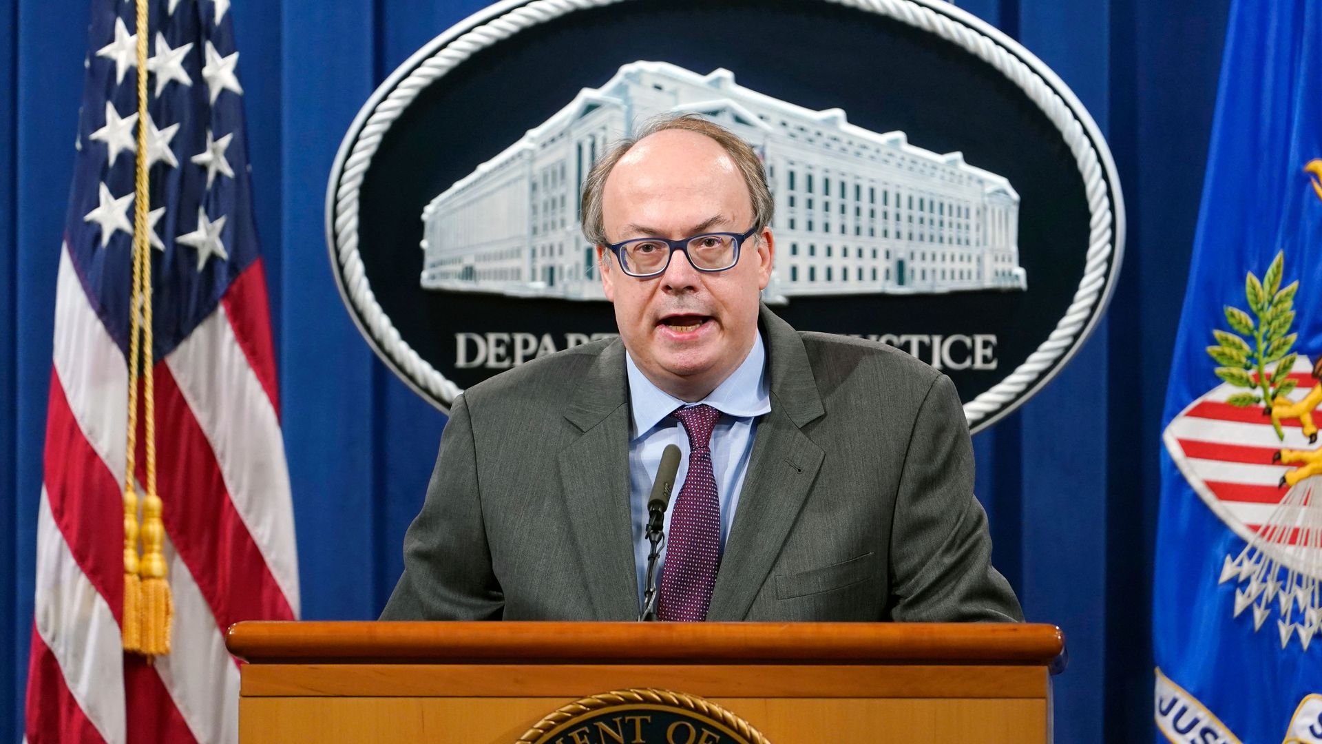 Photo of Jeffrey Clark speaking from a podium