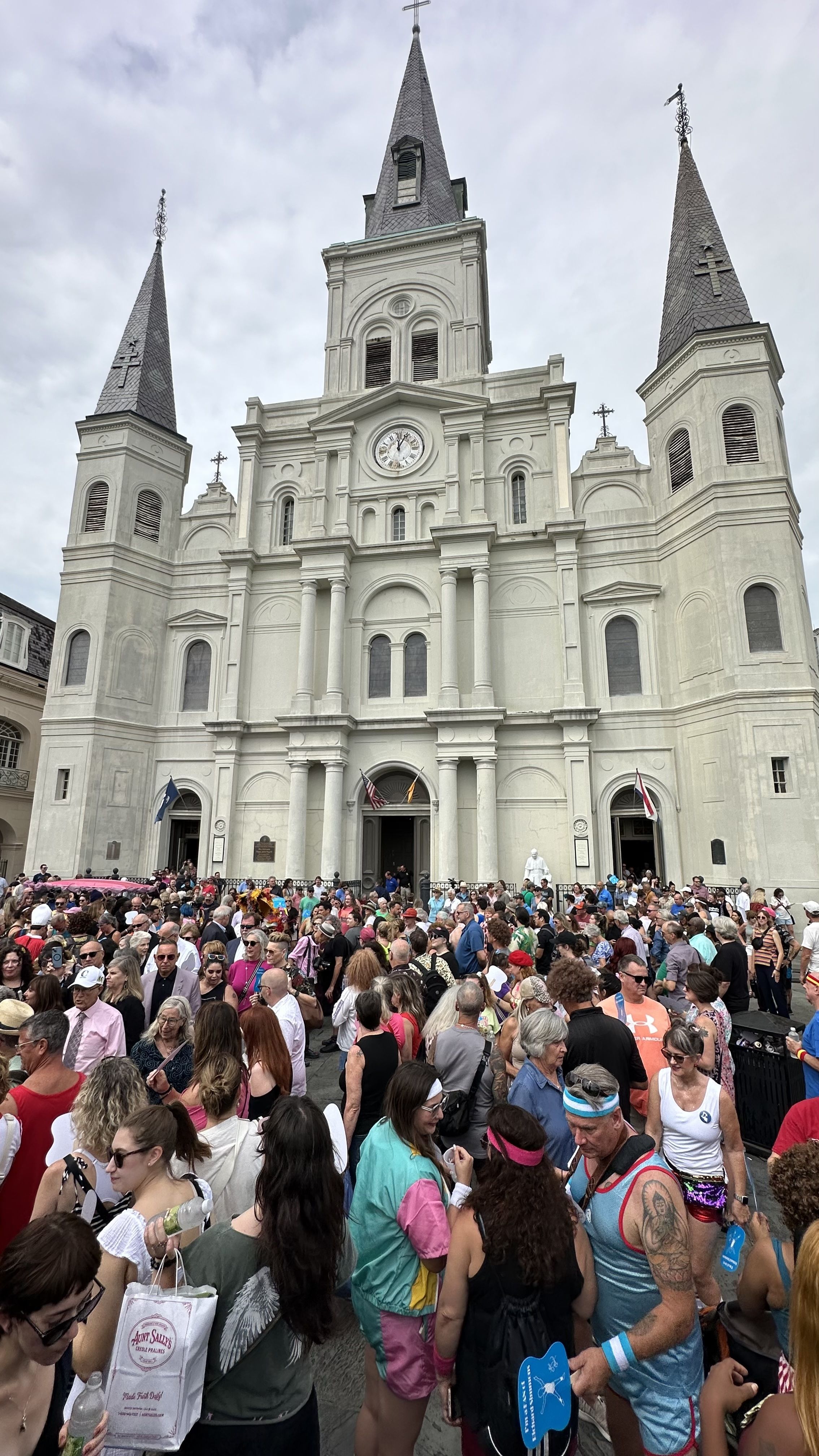 A large crowd gathers in front of the St. Louis Cathedral.