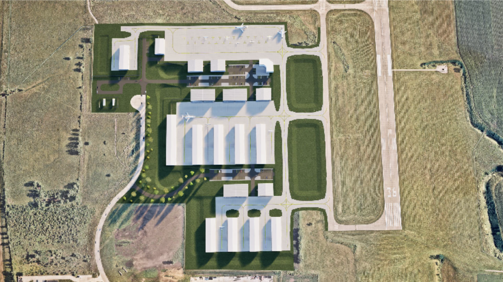 Aerial view of a small airport with a runway labeled 36, multiple hangars, parked airplanes, green lawns, and surrounding fields.