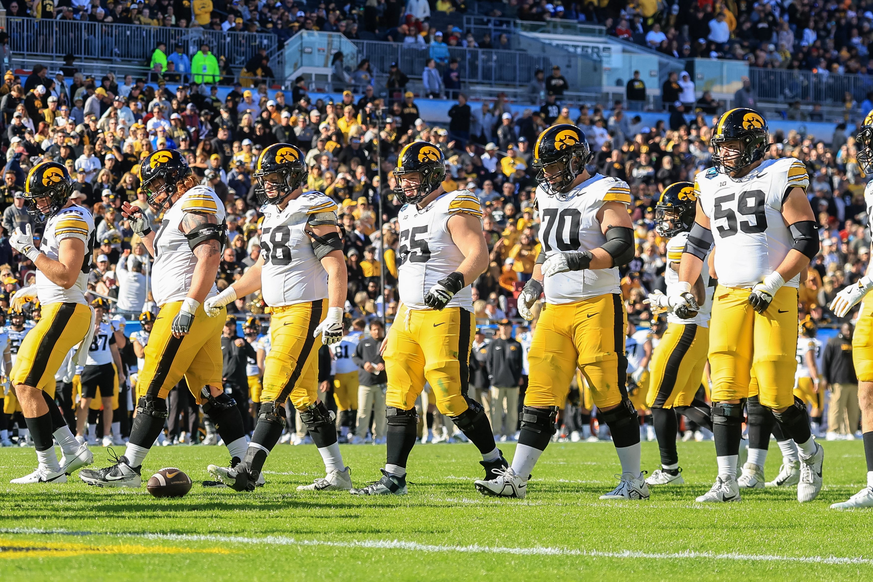 Members of the Iowa Hawkeyes offensive line walk up to the line of scrimmage against the Vanderbilt Commodores during the second half of the ReliaQuest Bowl at Raymond James Stadium on December 31, 2025 in Tampa, Florida. (Photo by Mike Carlson/Getty Images)