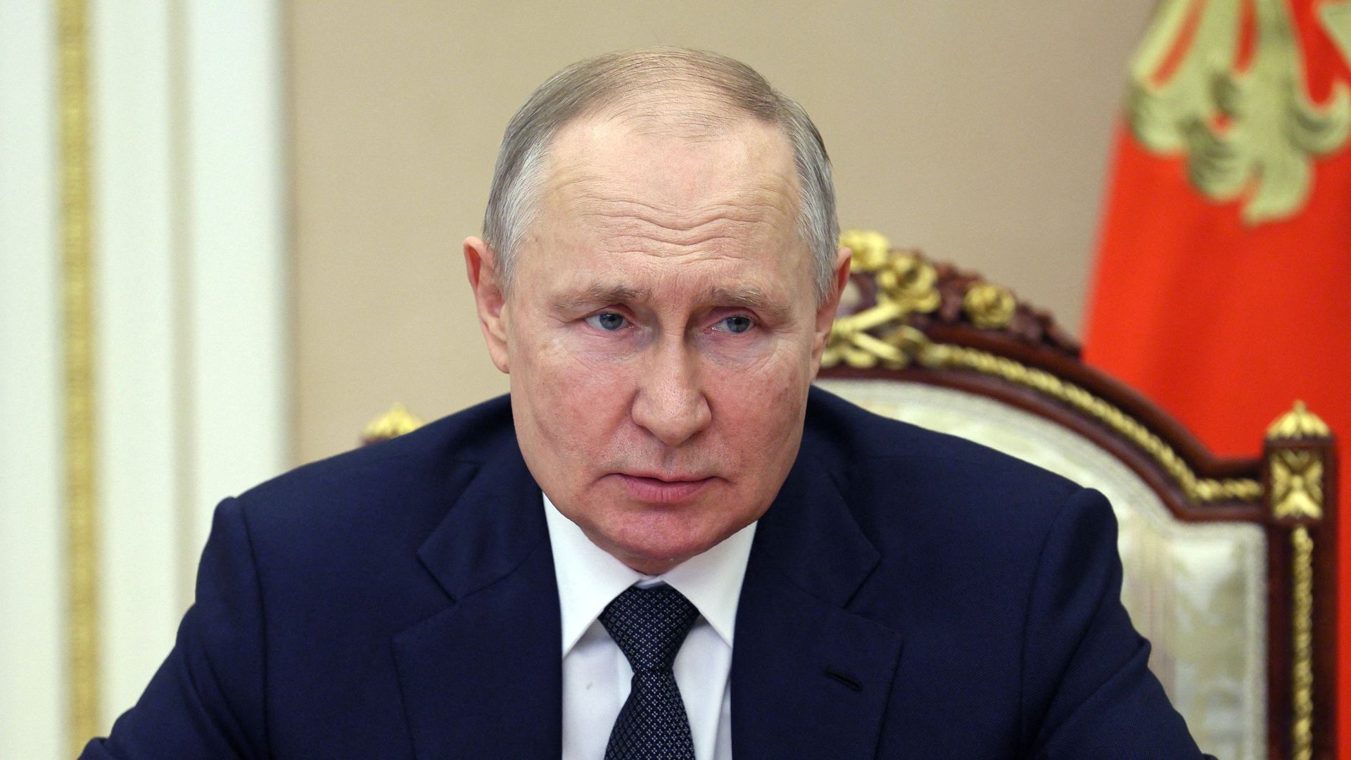 Photo of Vladimir Putin sitting and looking straight ahead