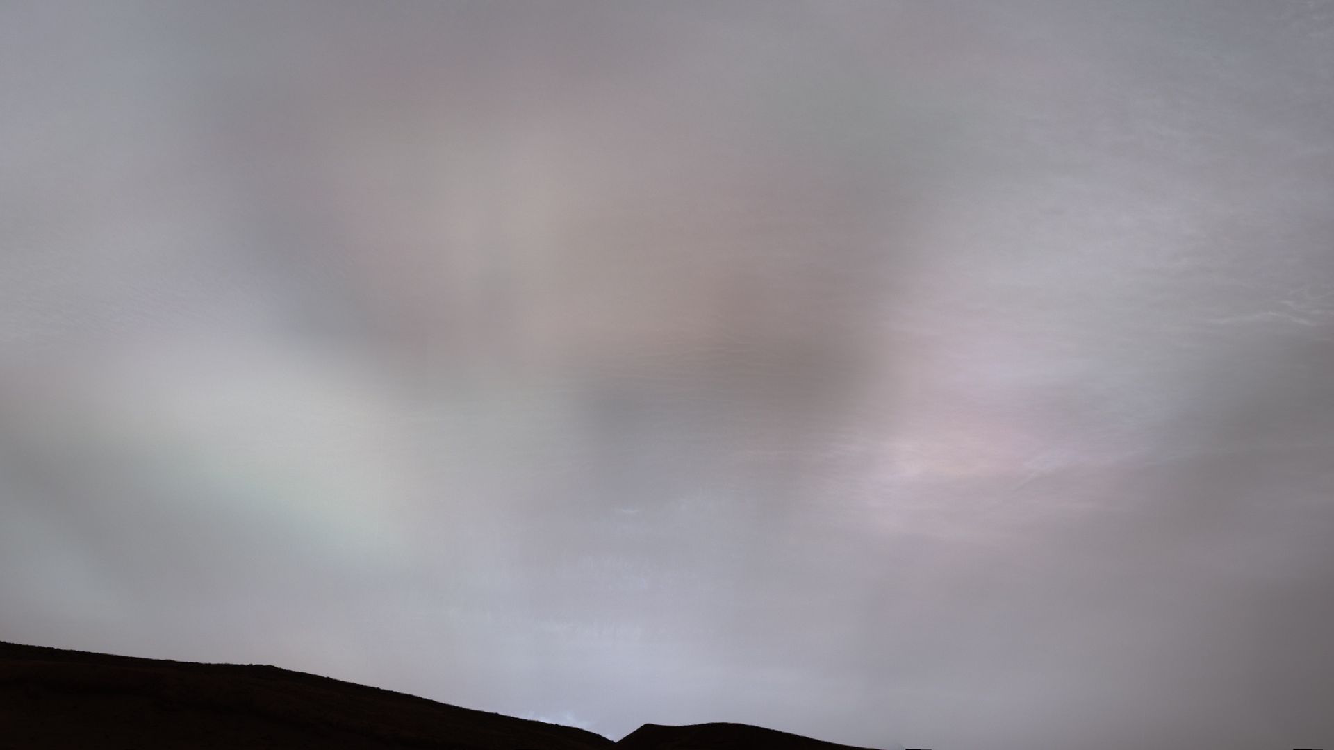 The Sun's rays shining through clouds on Mars shining in iridescence 