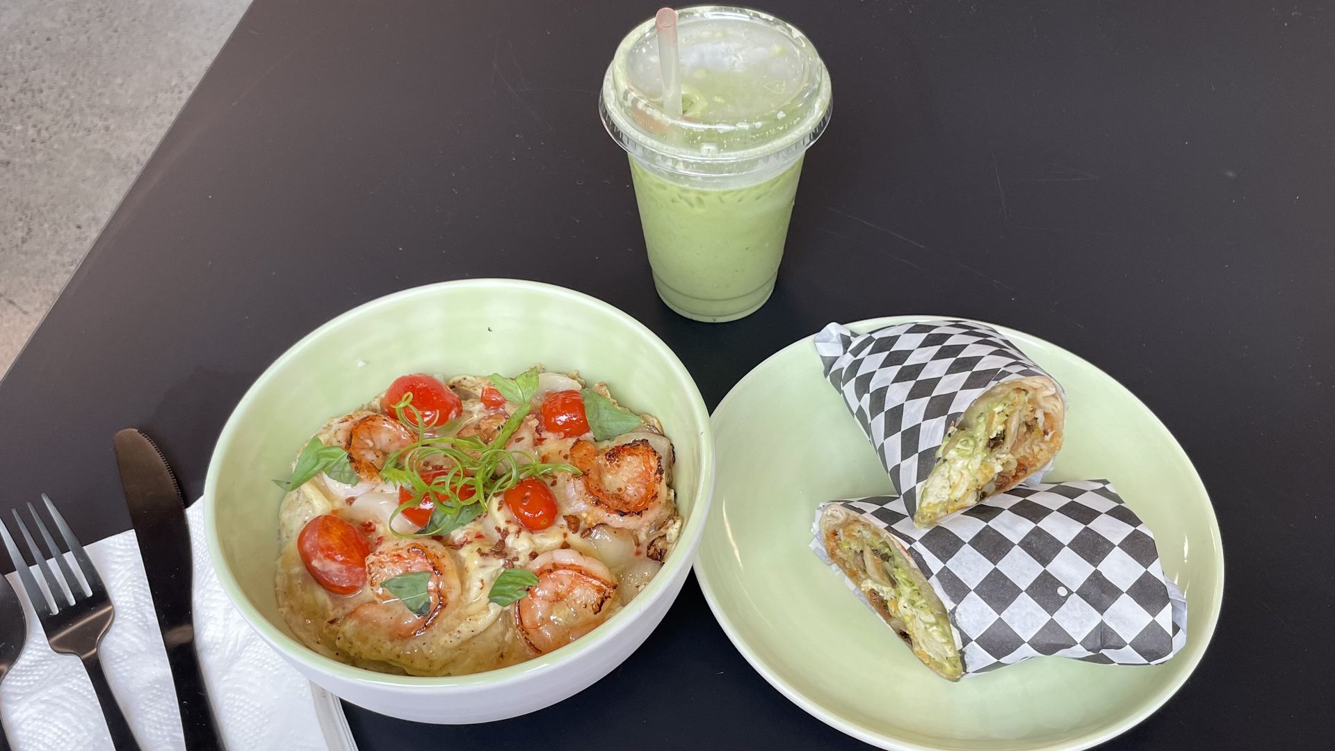 A photo of two plates on a black table.