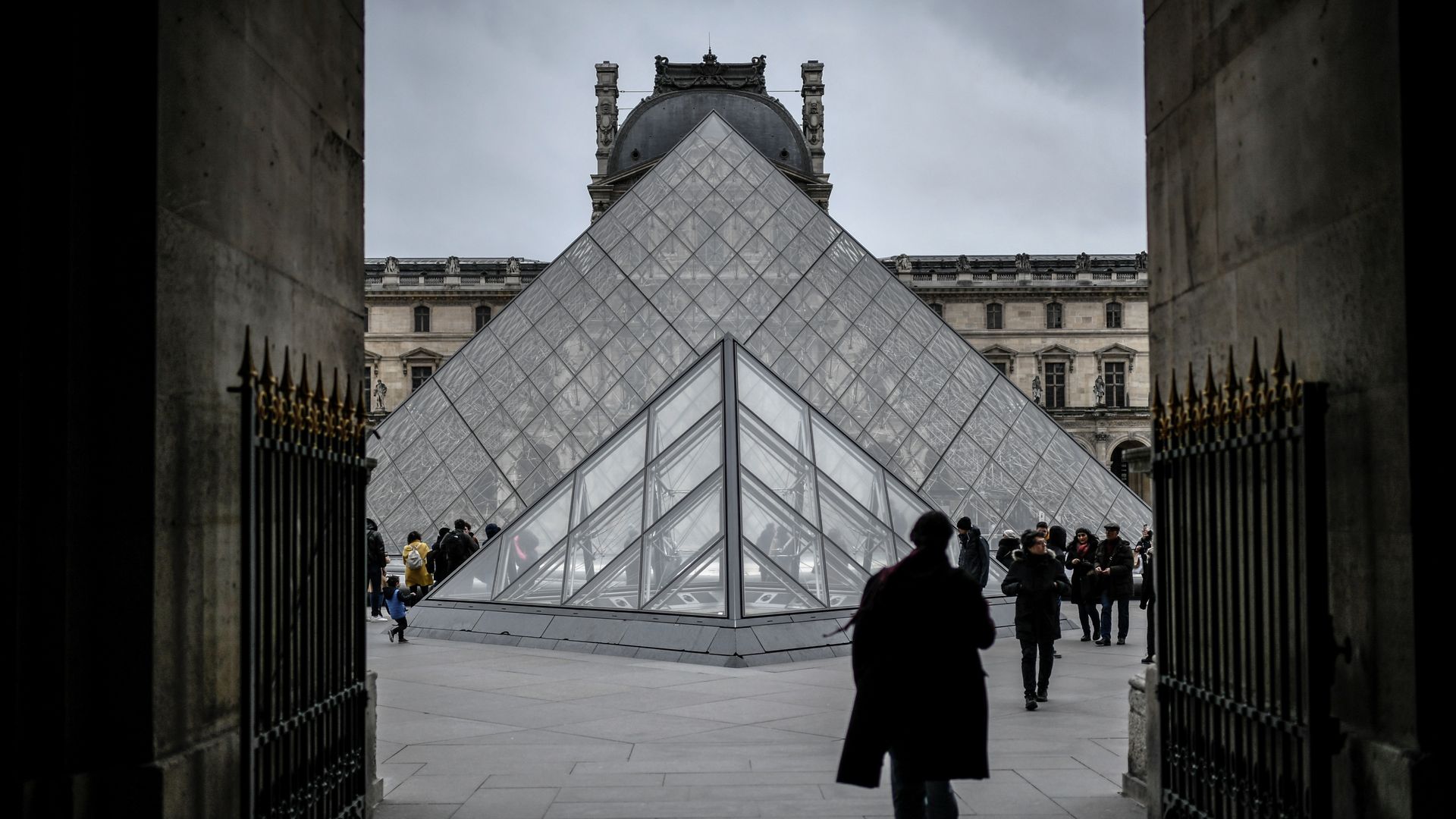 A person walking toward the Louvre Pyramide on Feb. 28 in Paris