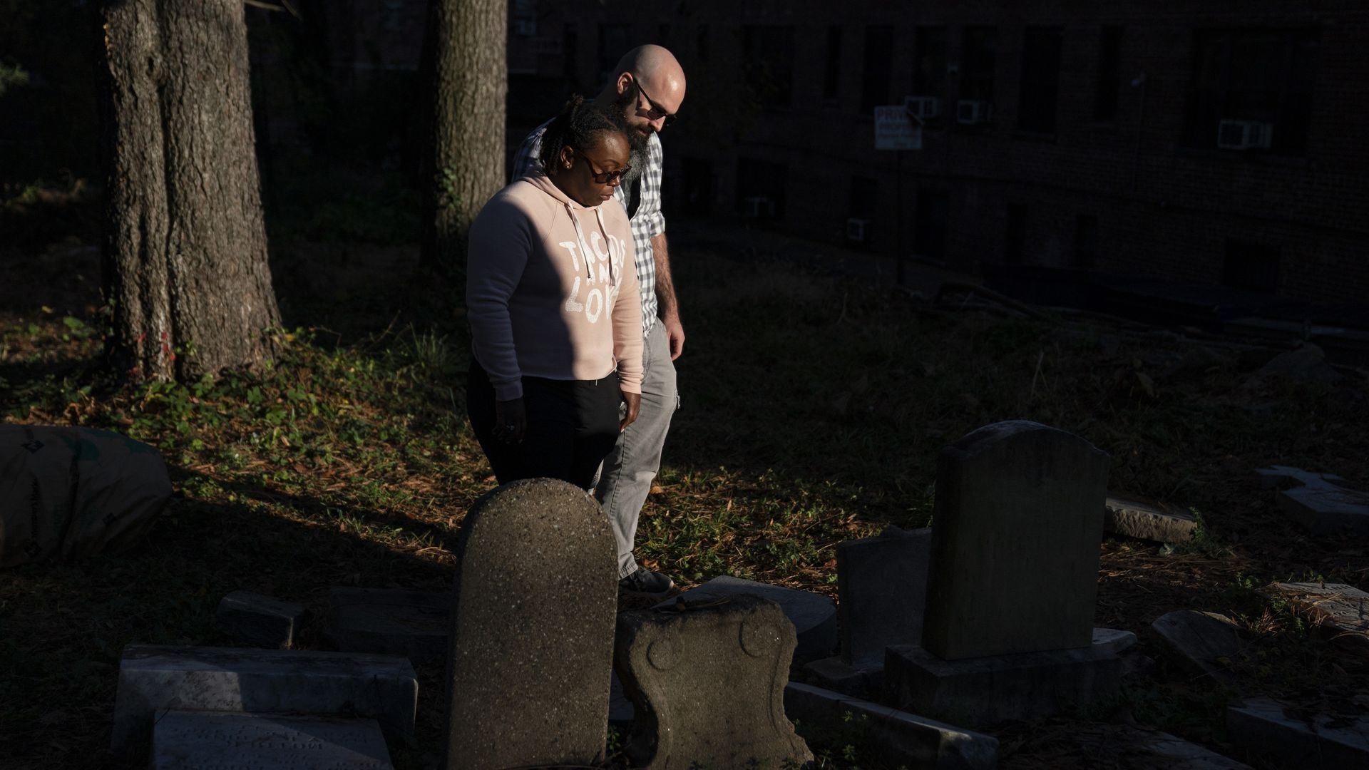Michelle Farris and her husband, Tim Farris, look at gravestones in Mount Zion Cemetery in D.C. Moses, her distant relative, is buried there in an unknown location. (Carolyn Van Houten/The Washington Post)