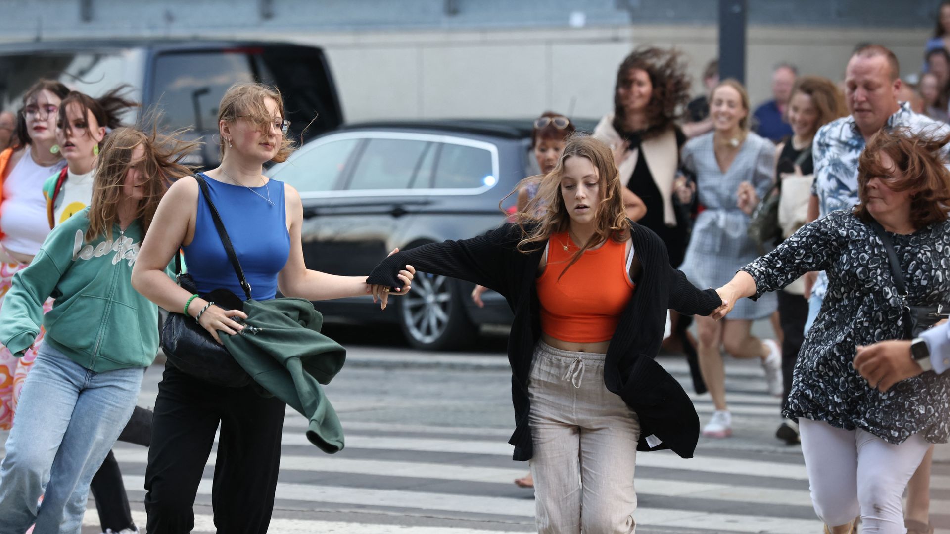 People are seen running during the evacuation of the Fields shopping center