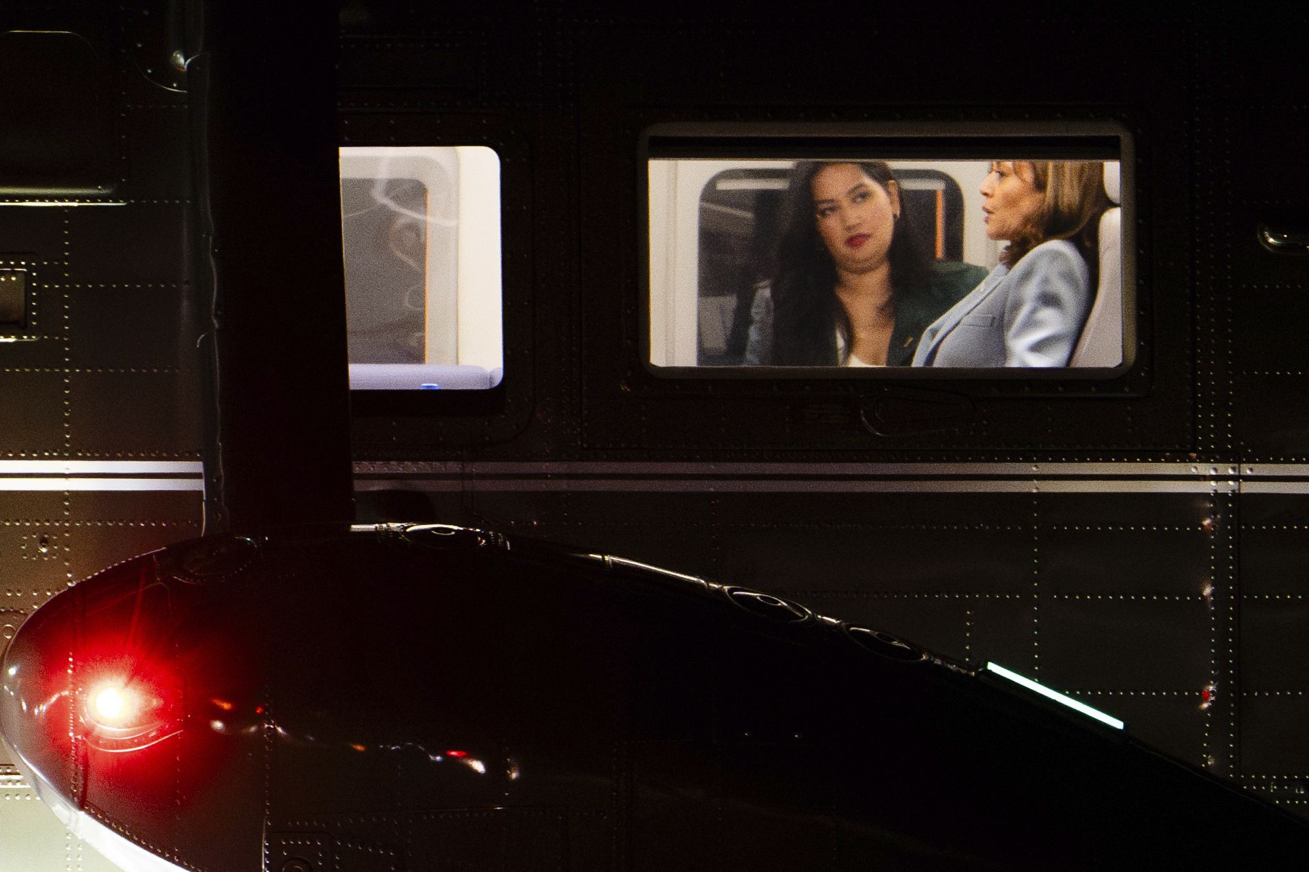 Vice President Harris talks with aide Opal Vadhan aboard Marine Two at Andrews Air Force Base on Tuesday.