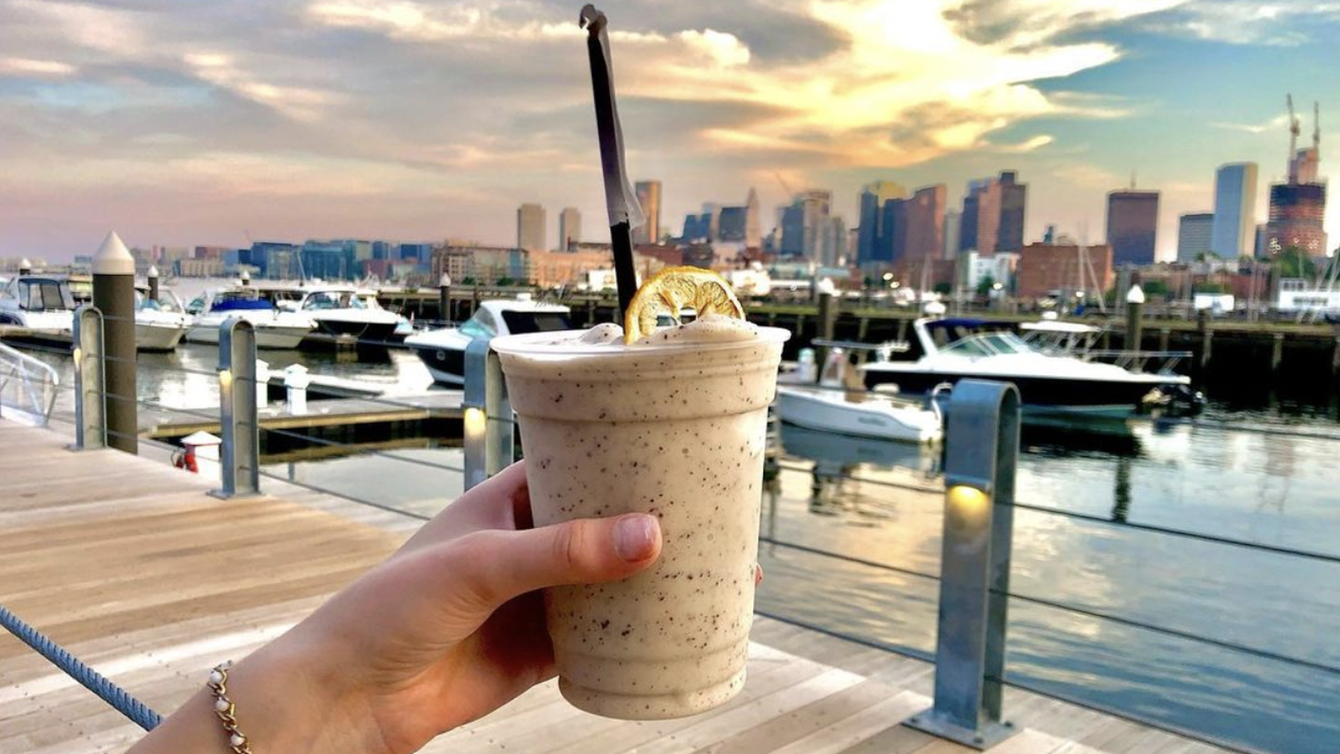 A woman holding the Pineapple Espresso frozen cocktail