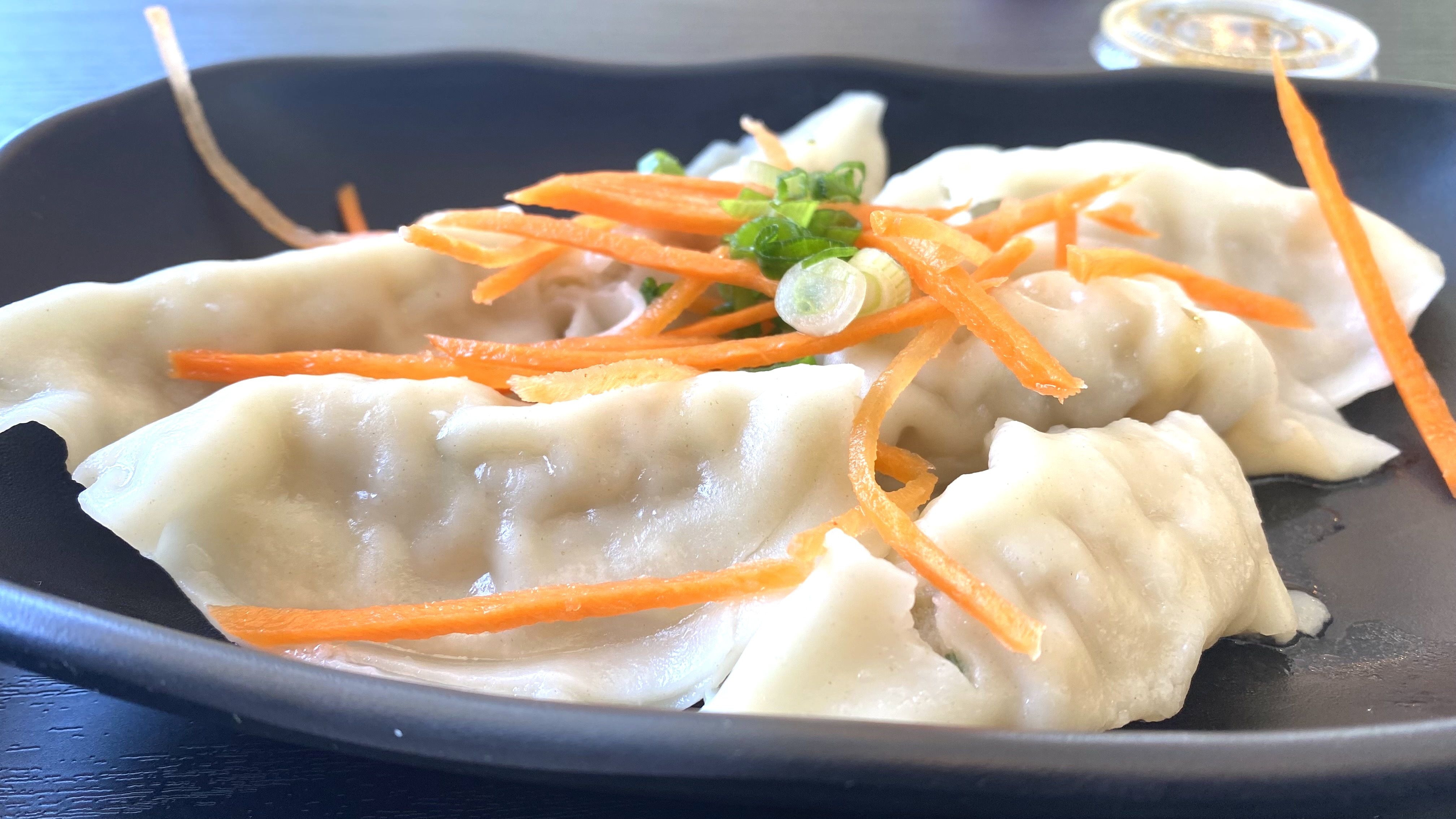 A photo of a plate of dumplings.