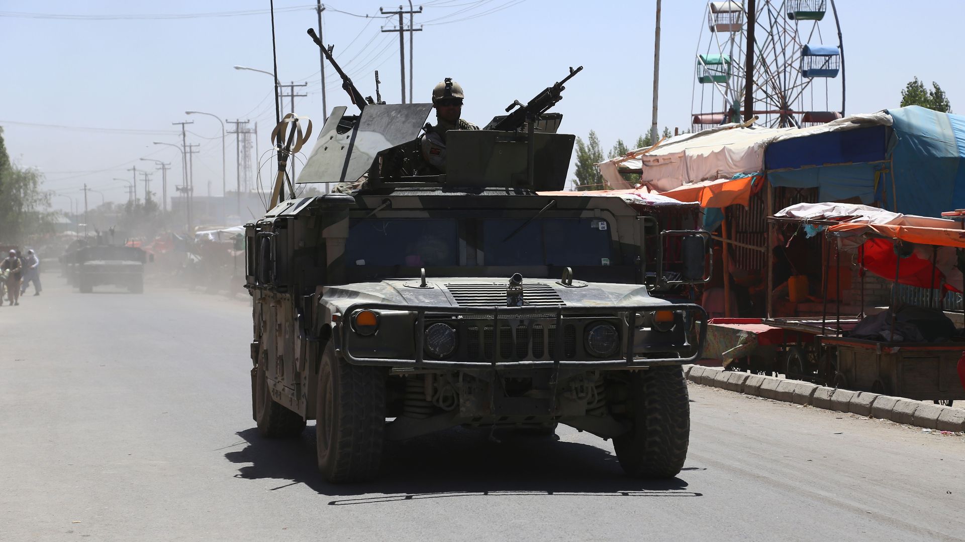 Afghan security forces drive in a tank.