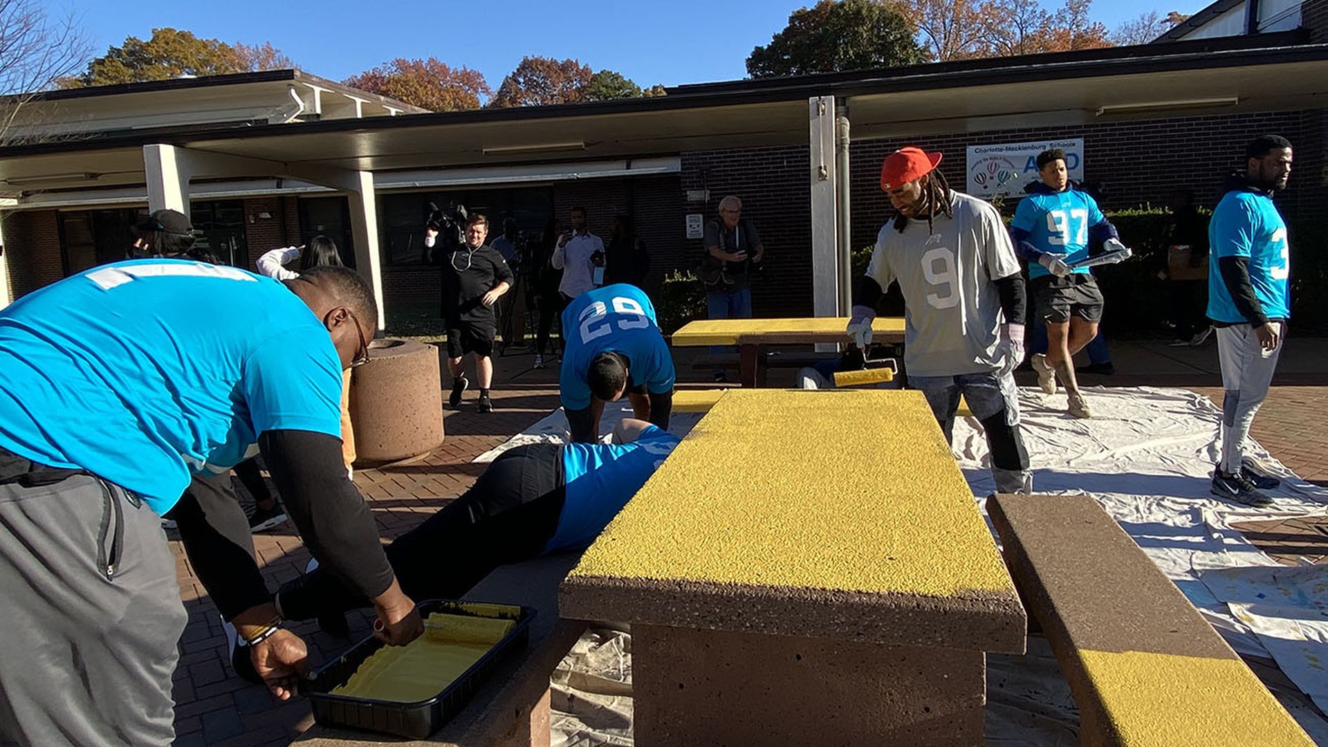 Carolina Panthers paint Harding University High School's outdoor picnic area. Photo: Ashley Mahoney/Axios