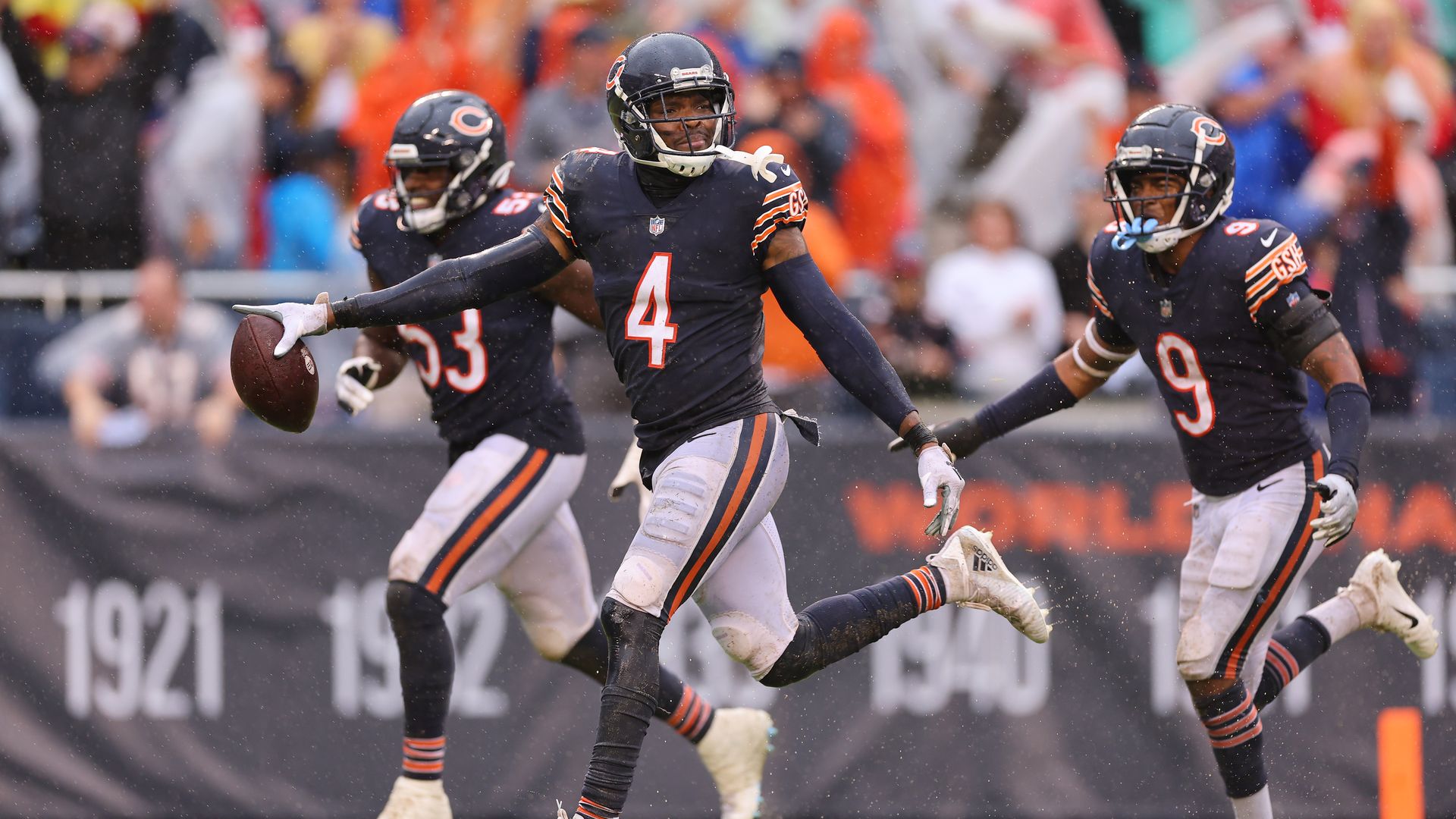 Photo of football players running 