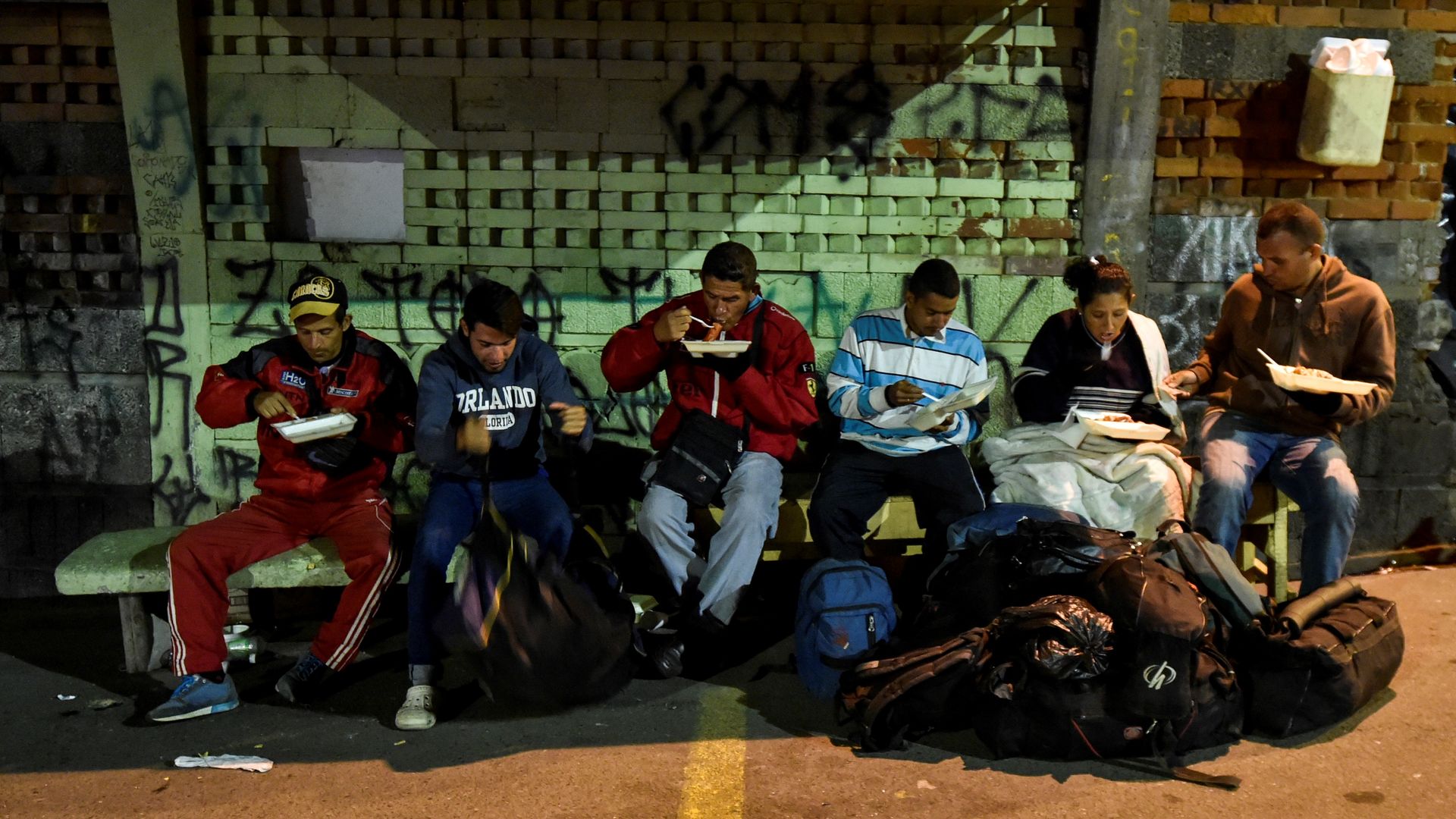 Venezuelan refugees eating in the street