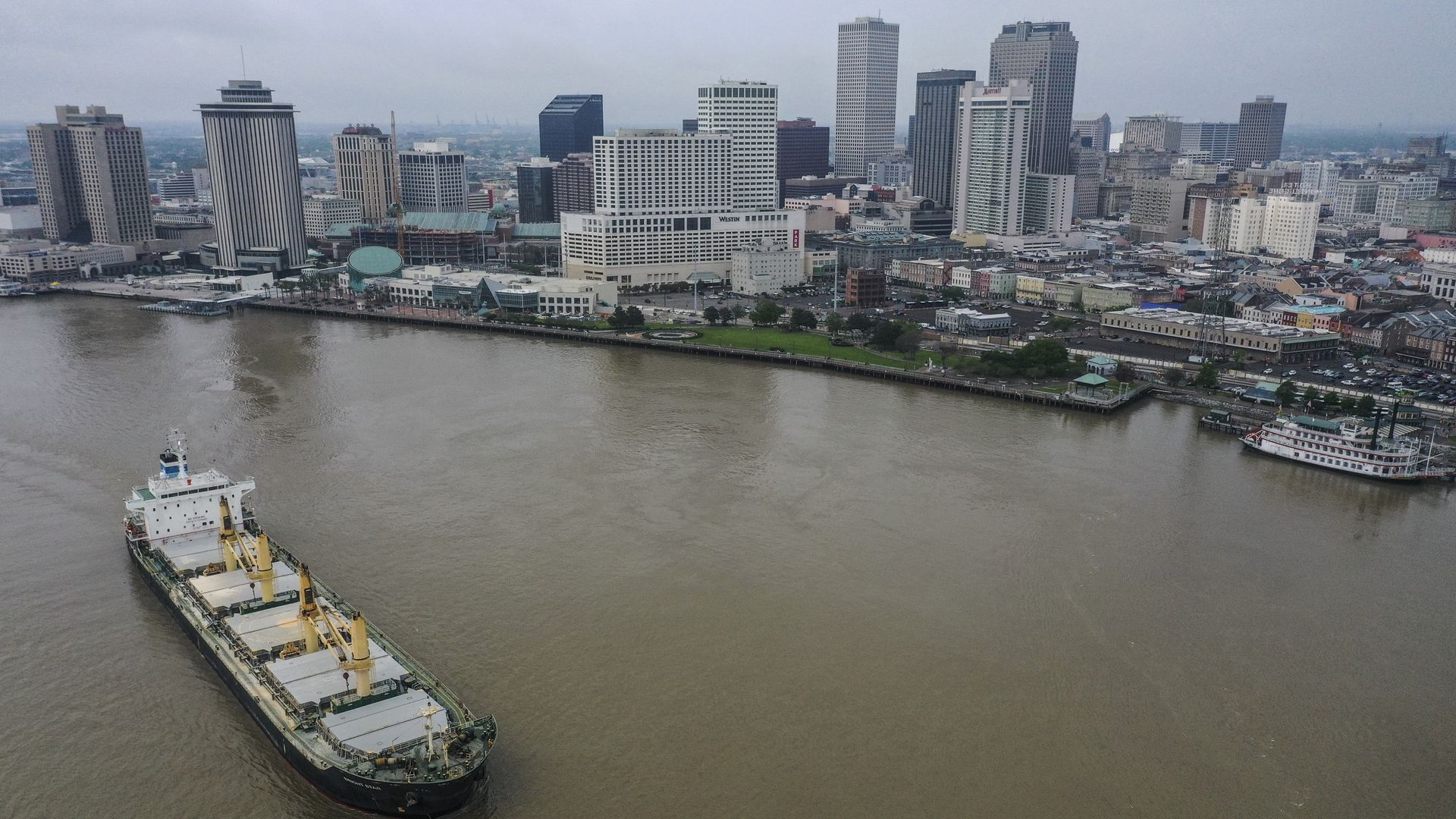 Photo shows the Mississippi River with the New Orleans skyline in the background