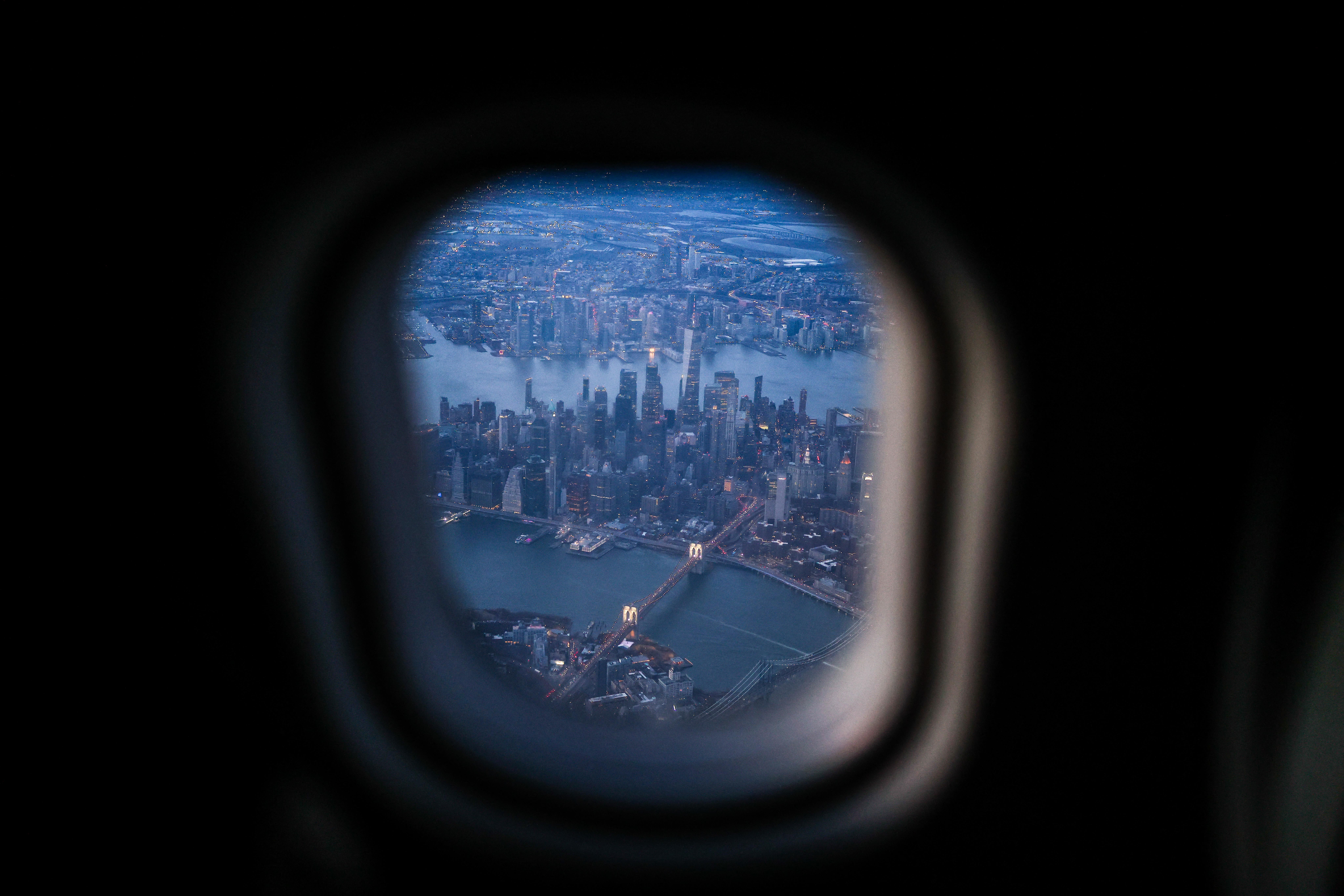 View of Manhattan and Brooklyn through the window of a landing plane