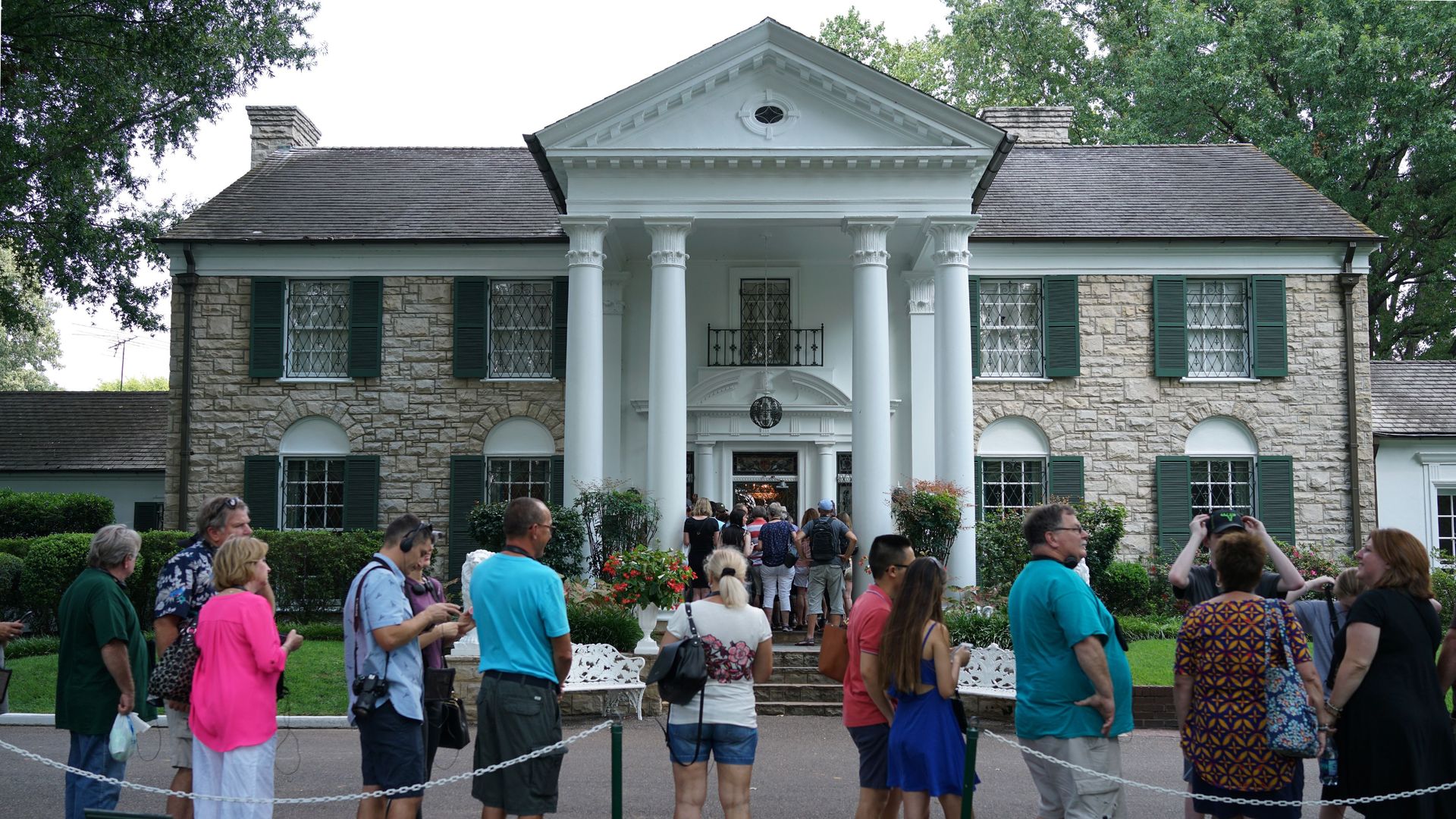 Visitors queue to enter the Graceland mansion of Elvis Presley on August 12, 2017 in Memphis, Tennessee.