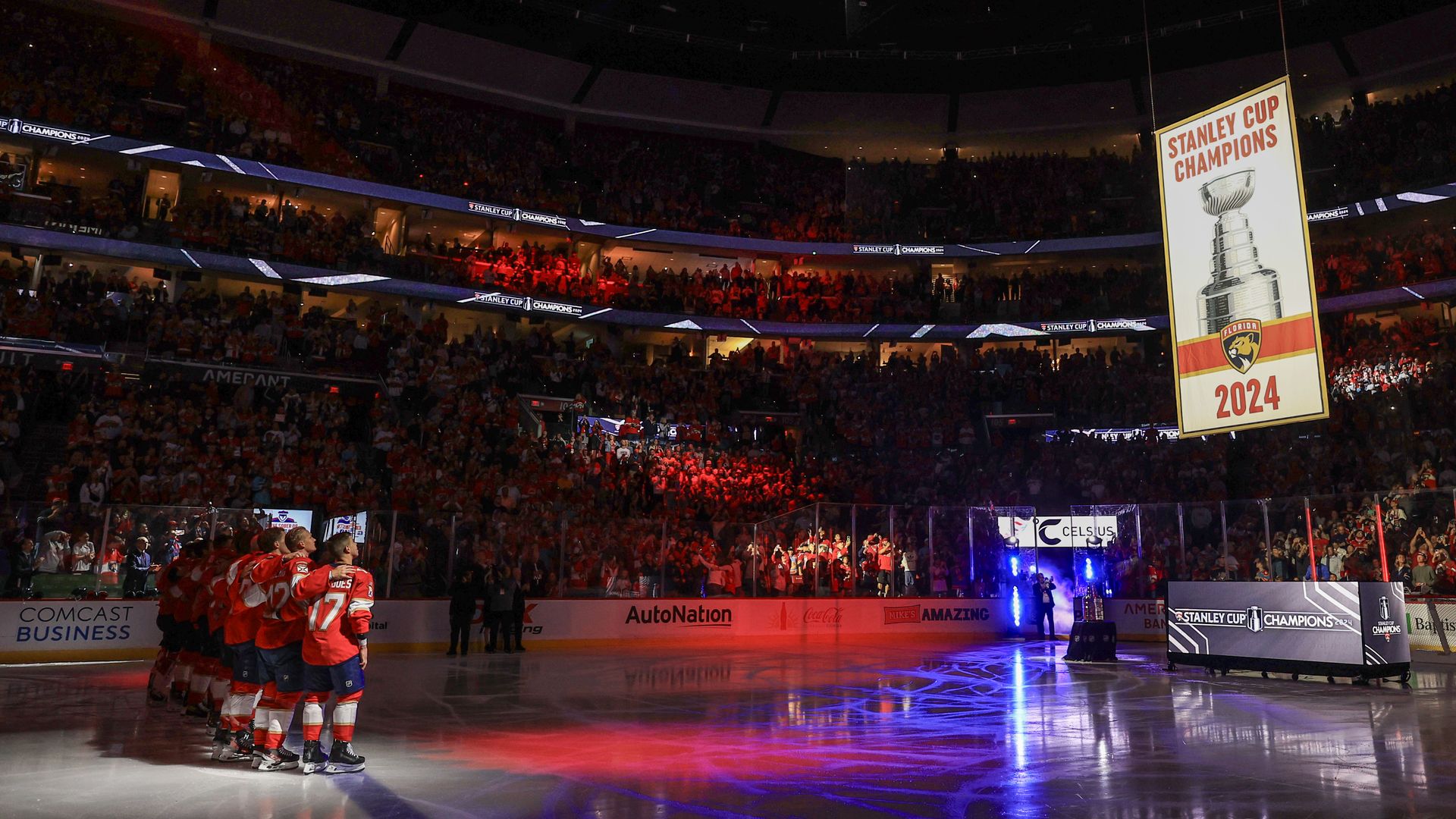 The 2024 Stanley Cup championship banner is raised over the ice during a ceremony before the Florida Panthers' home opener against the Boston Bruins at Amerant Bank Arena 