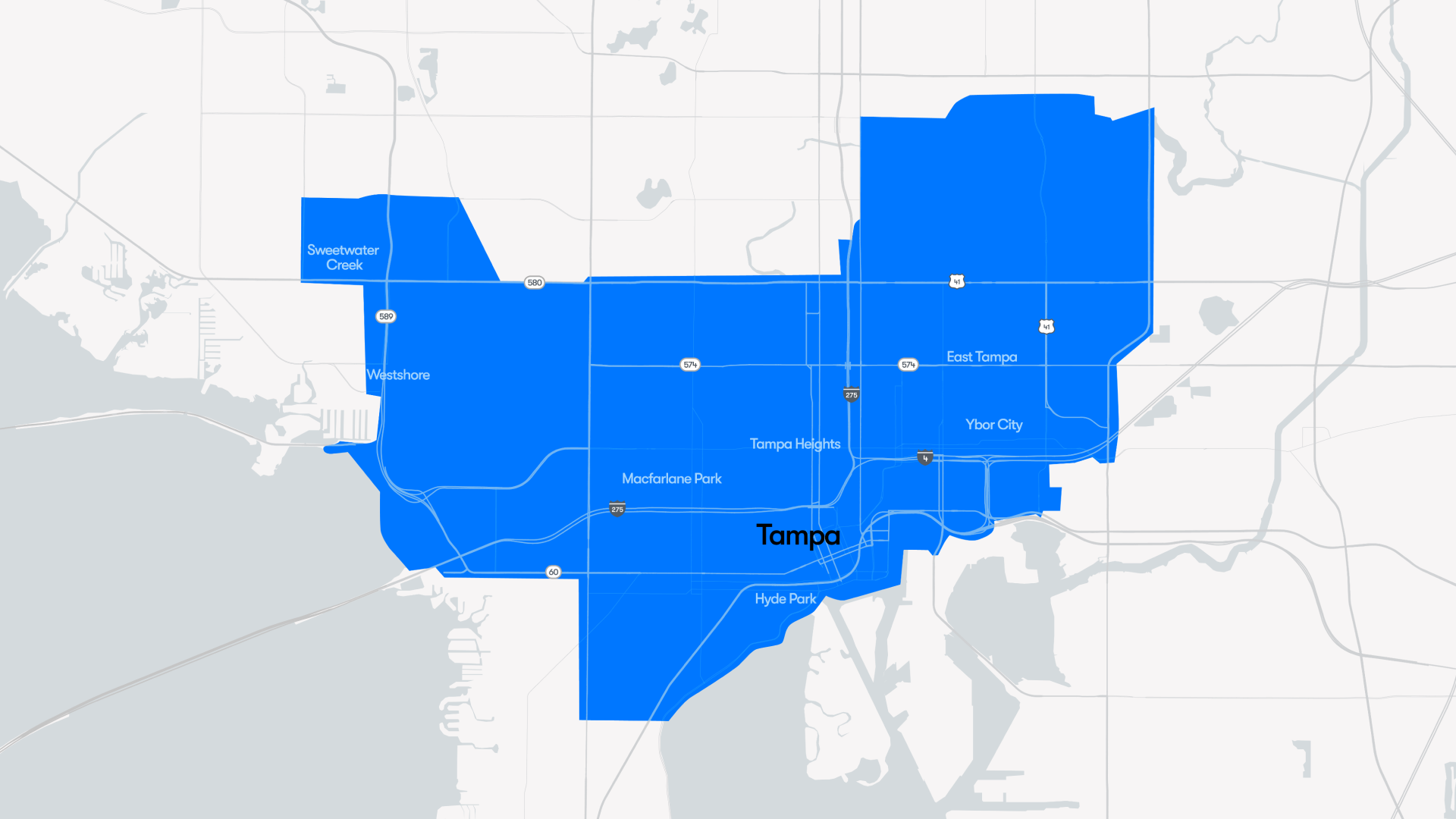 Stylized map of Tampa, FL with a large blue highlight covering central and southern Tampa; labels show East Tampa, Ybor City, Tampa Heights, Westshore, Hyde Park, and MacFarlane Park.