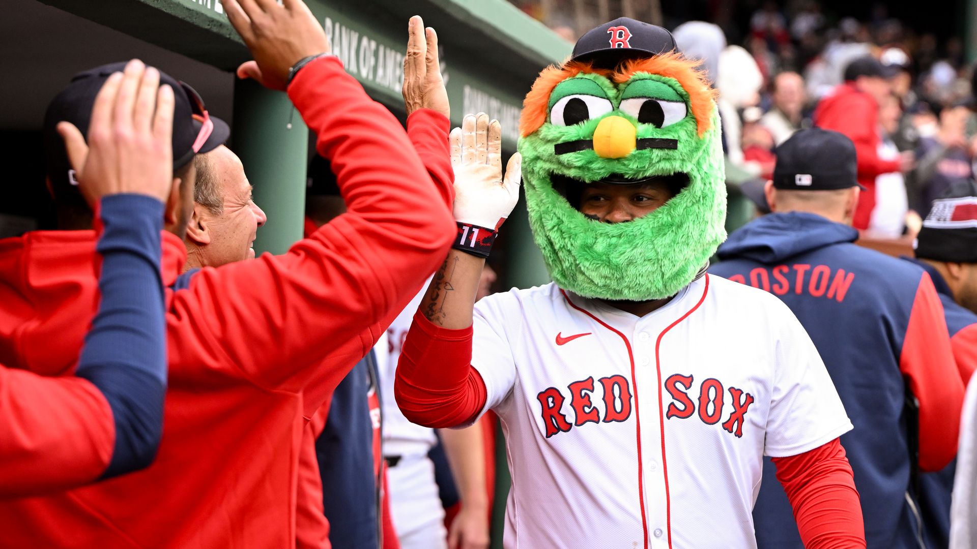 A baseball player in a mascot head