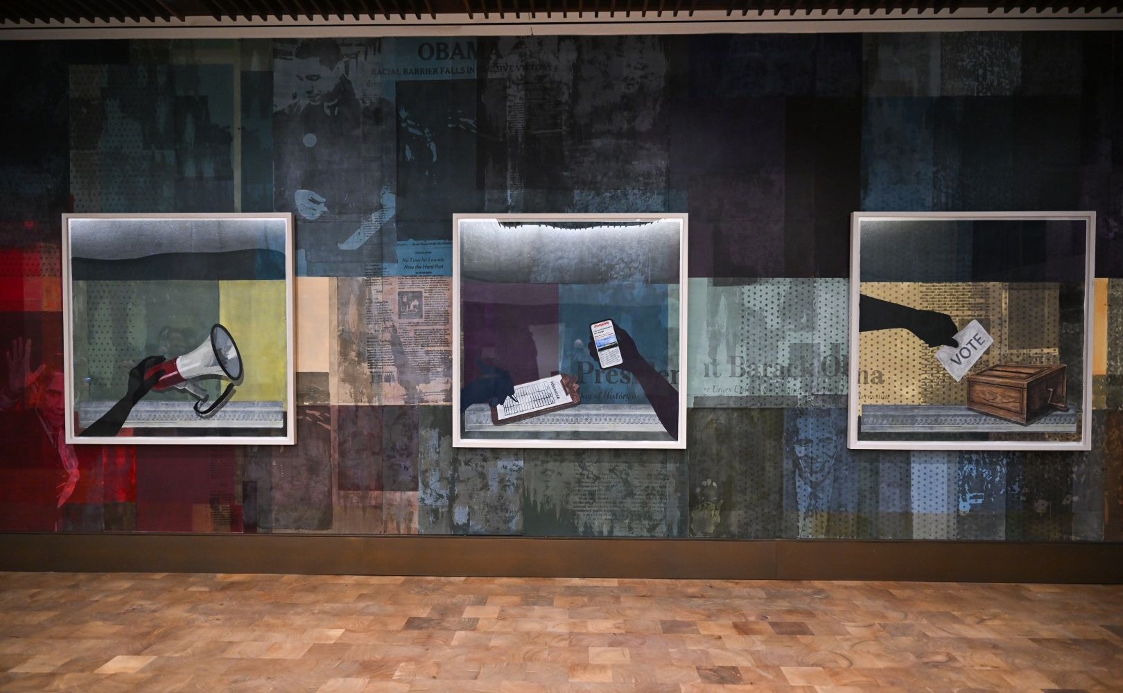 Three framed collage artworks on a dark, patchwork wall. Left: a hand holding a megaphone. Center: hands with a clipboard and a card. Right: a hand inserts a ballot into a wooden box labeled VOTE.