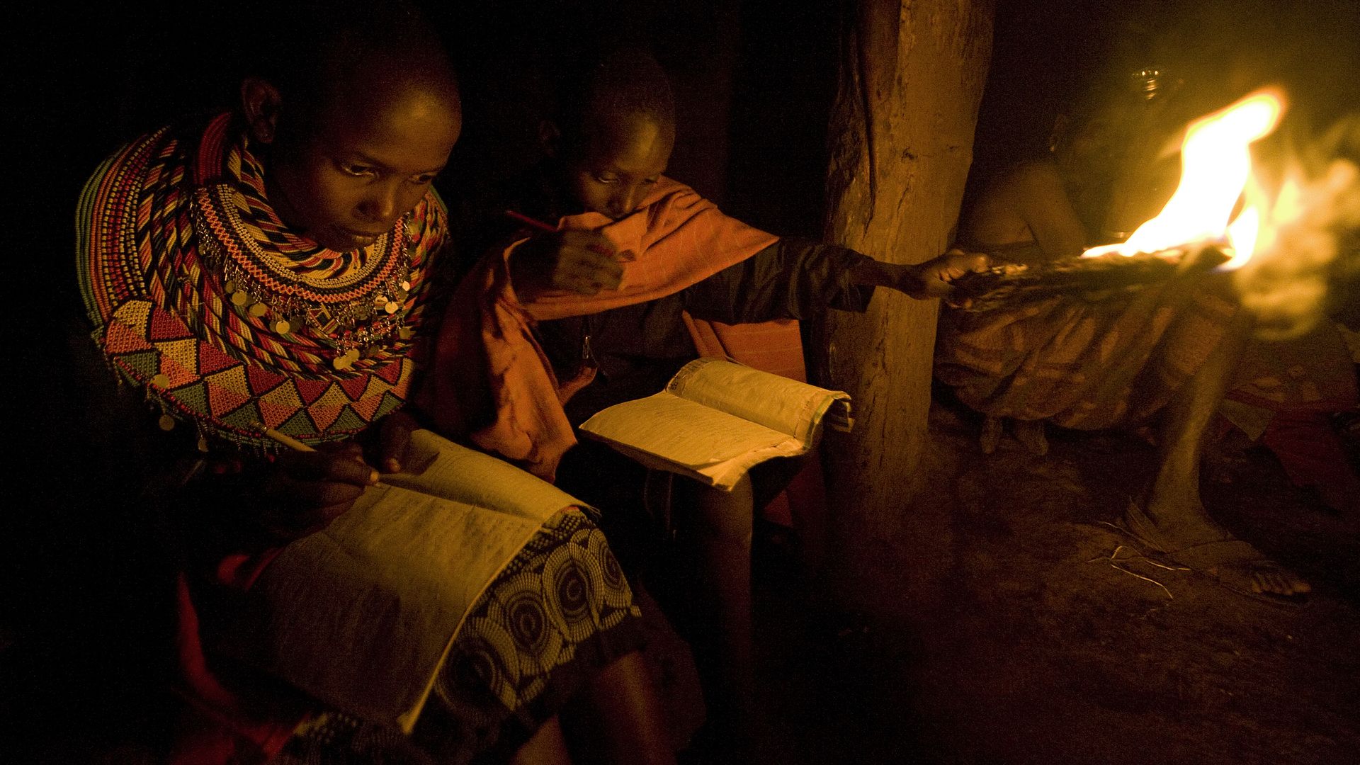 Photo of children in Kenya studying by firelight